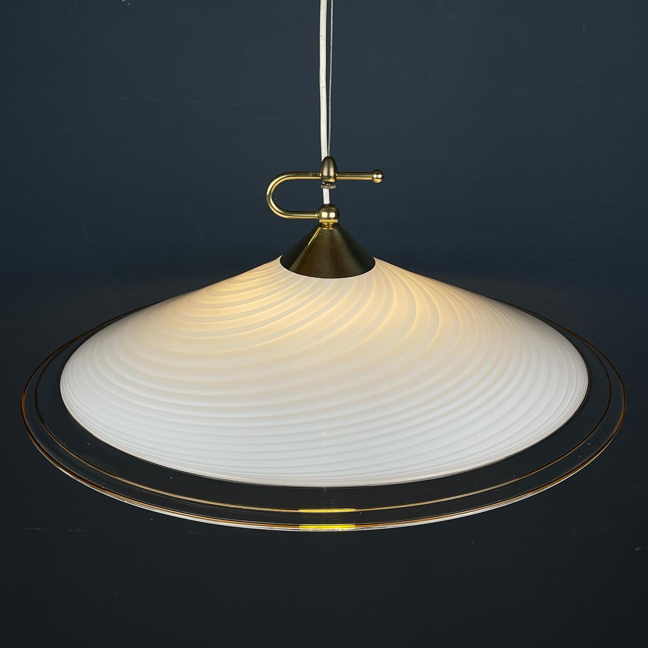 Behold this mesmerizing vintage Murano pendant lamp, a true masterpiece from the 1970s, skillfully crafted by Vetri Murano 004 in Italy. Its swirling white Murano glass, expertly formed into a captivating dome shape, exudes elegance and