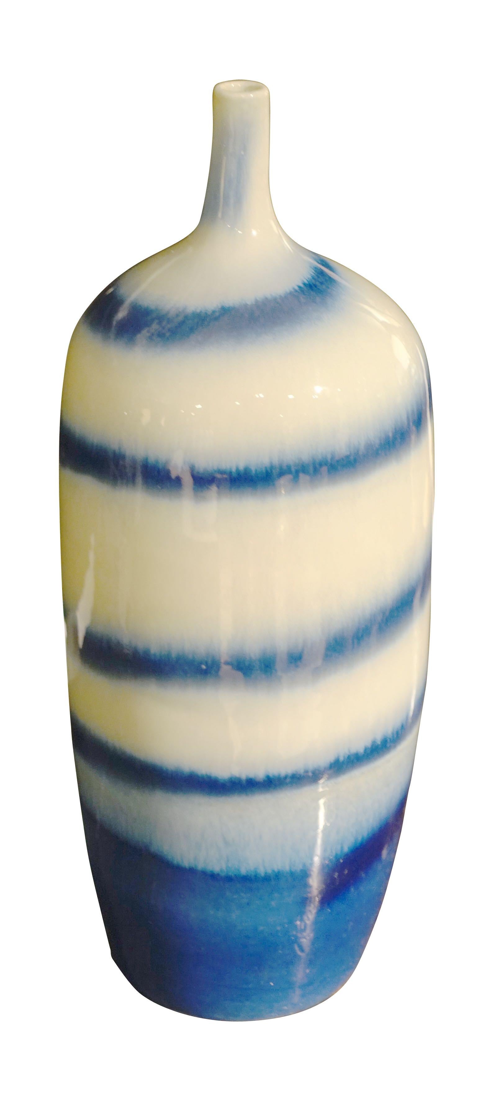 Contemporary Chinese shades of blue and white swirl pattern thin neck vase.
Two are available and sold individually.