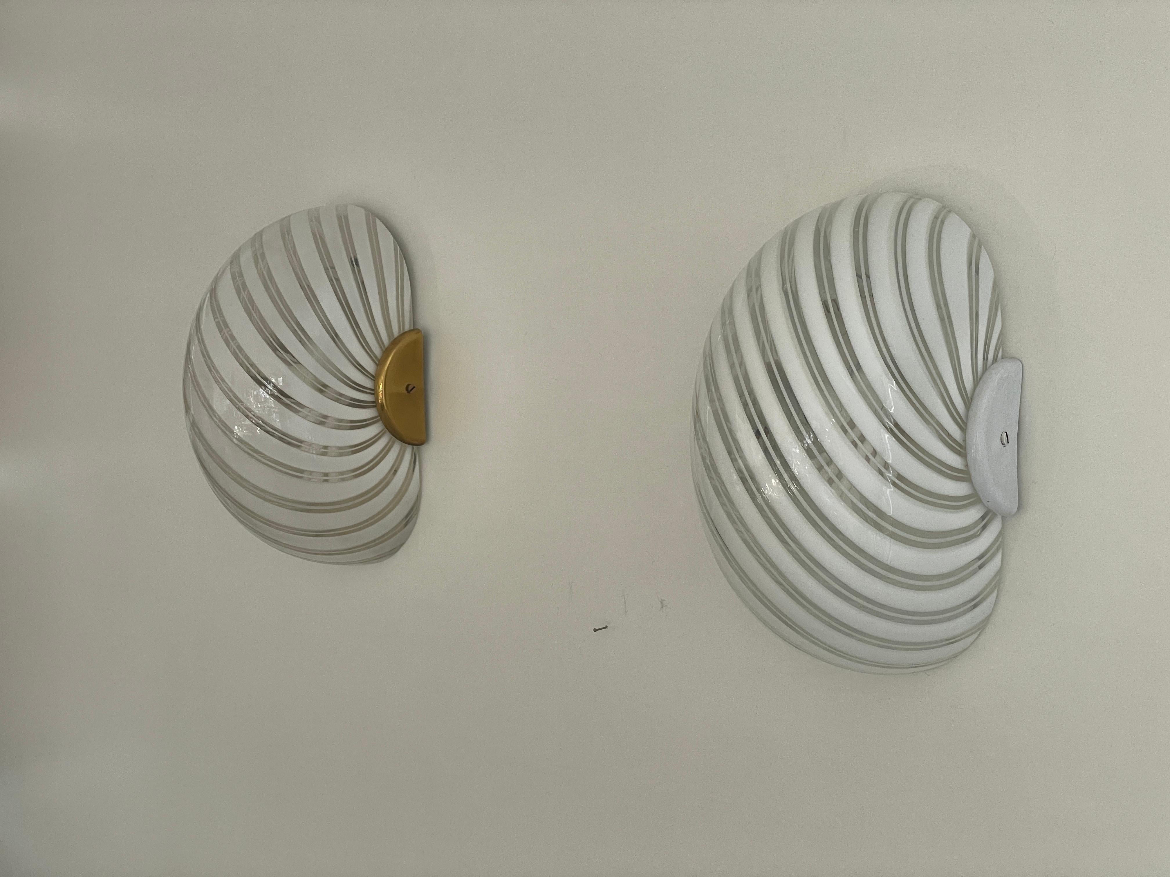 Wirbelmuster Murano Glas Paar Wandleuchter von F. Fabbian, 1970er Jahre, Italien

Sehr elegante und minimalistische Wandlampen.
Die Lampe ist in sehr gutem Zustand.

Diese Lampen funktionieren mit E27 Standard-Glühbirnen. 
Verkabelt und für den