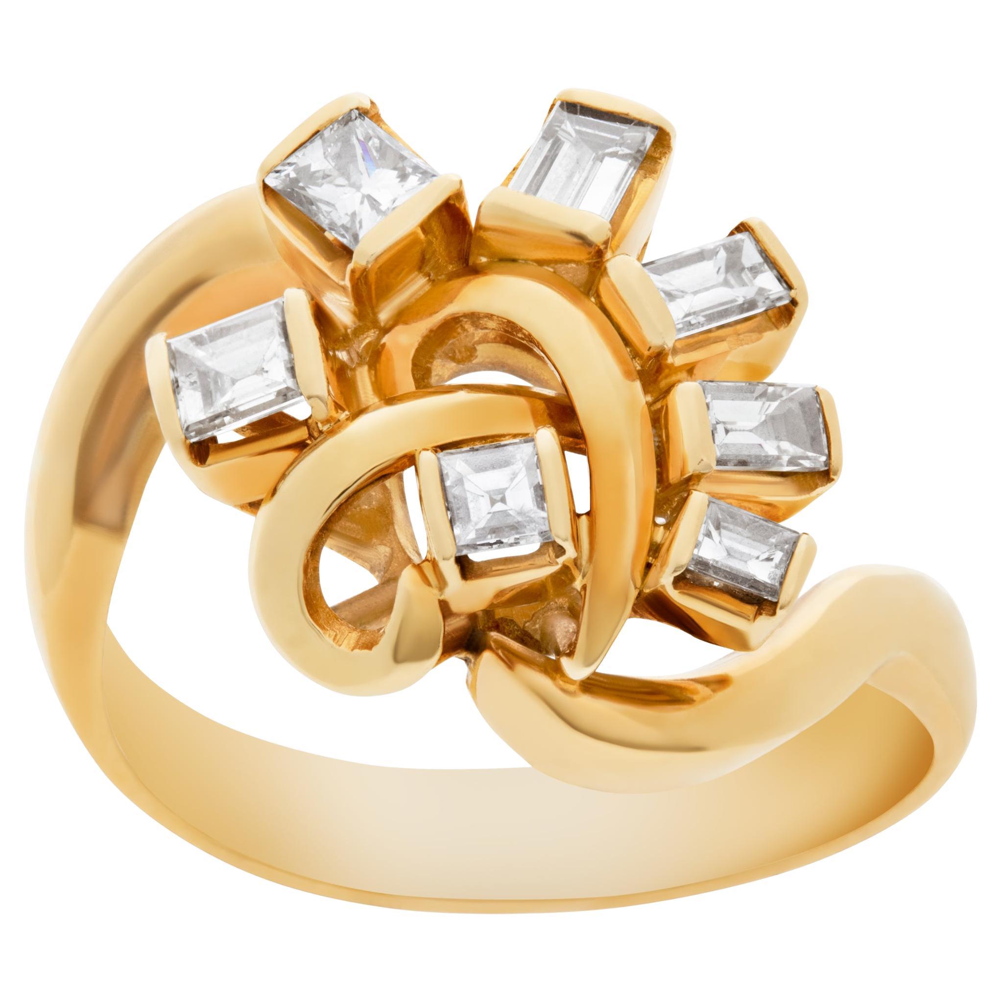 Swirl ring with diamonds set in 18k yellow gold