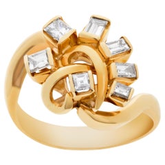 Swirl ring with diamonds set in 18k yellow gold