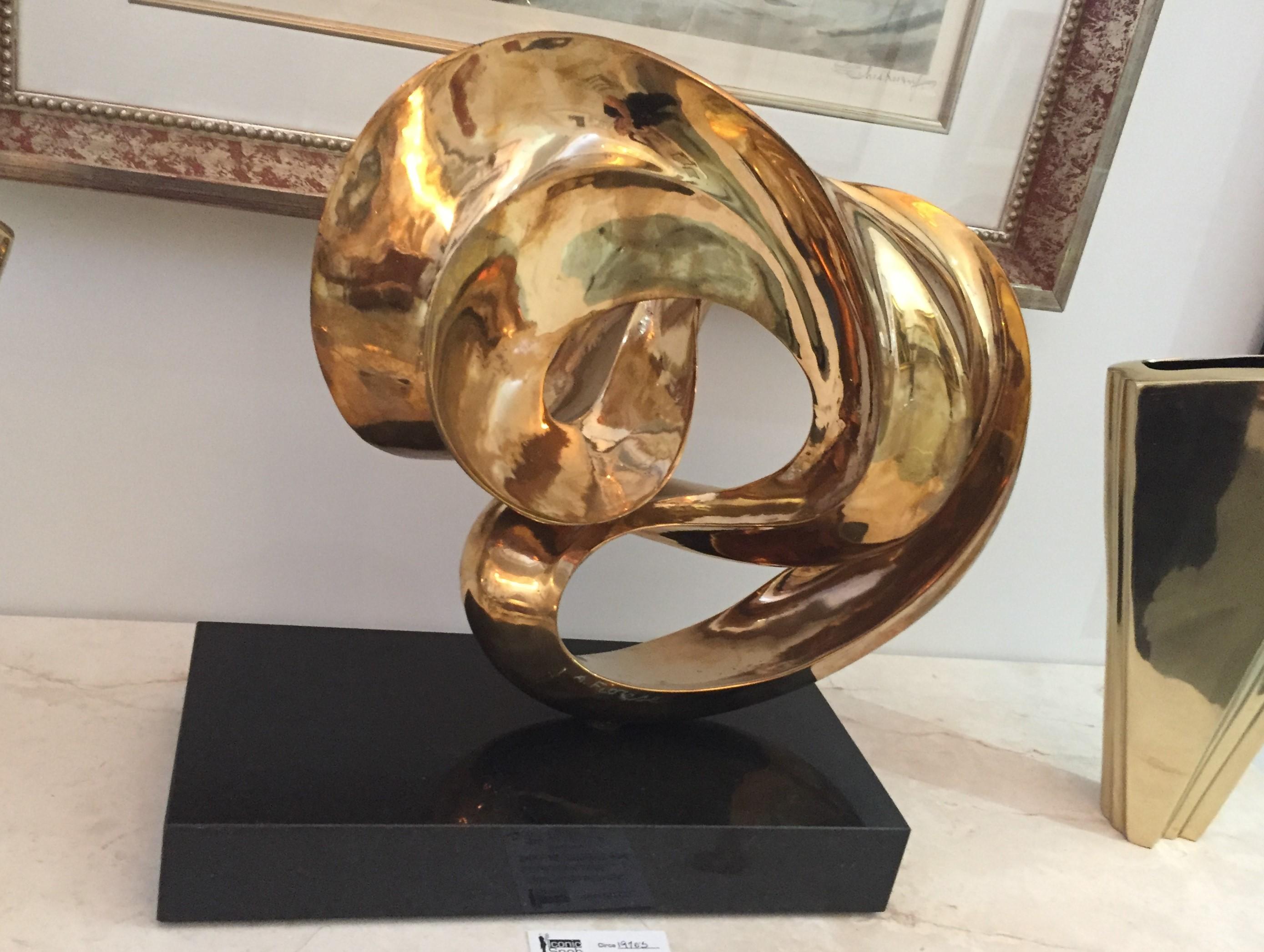 Swirl sculpture gold wash over bronze by Amedeo Fiorese. This sculpture can rotate on its base. Signed by the artist.

Note: base measures 2.5 x 15.75 x 7.88.