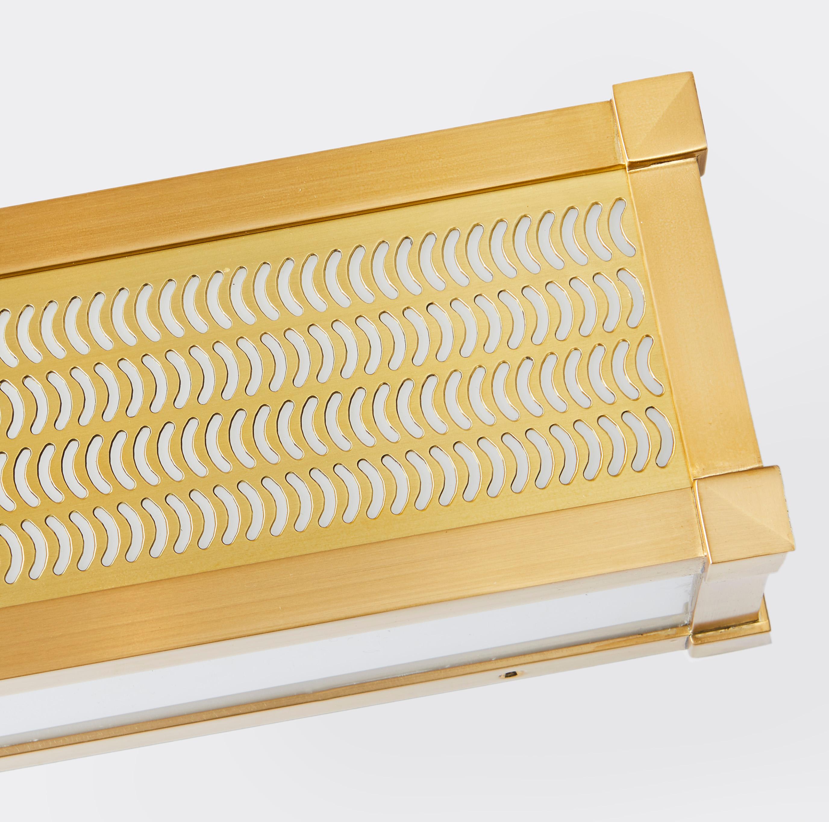 A rectangular, horizontal box-shaped light fixture. The brass frame engraved with comma shaped cut outs which emit light. Panels feature bevelled corner details, while the front sides and underside are fitted with opal plexi diffusers. 

As part