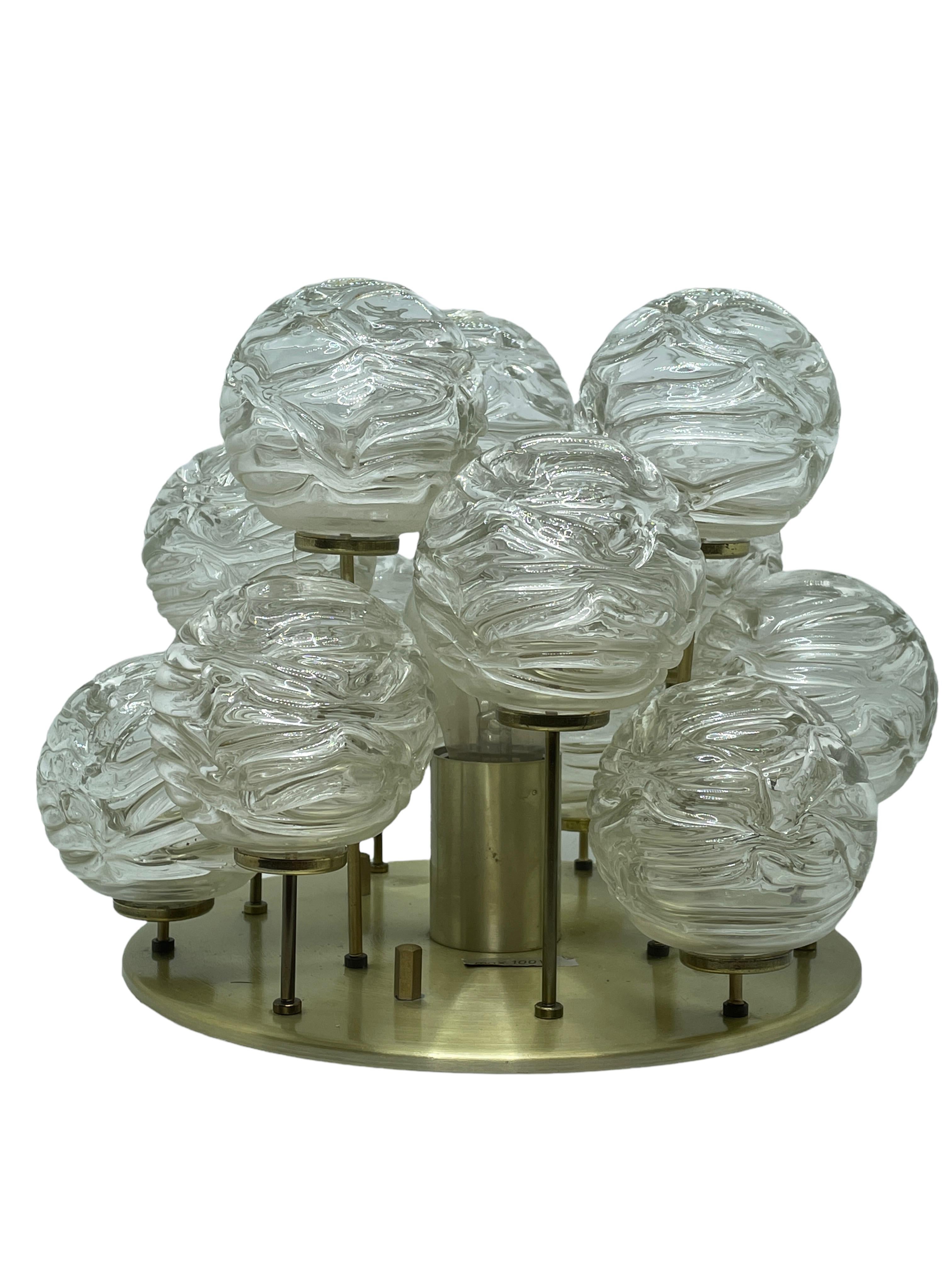 Swirled glass ball flush mount fixture by Doria Leuchten, Germany. The handblown glass ball elements are attached to brass rods in varying lengths that when illuminated by the single light source makes a beautiful light. The Fixture requires a