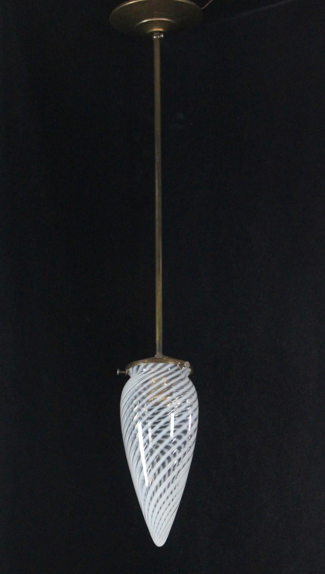 Late 20th Century Vaseline glass shade with swirls caps off this brass pendant light with pole. Brass hardware and wiring is new. Please note, this item is located in our Scranton, PA location.
