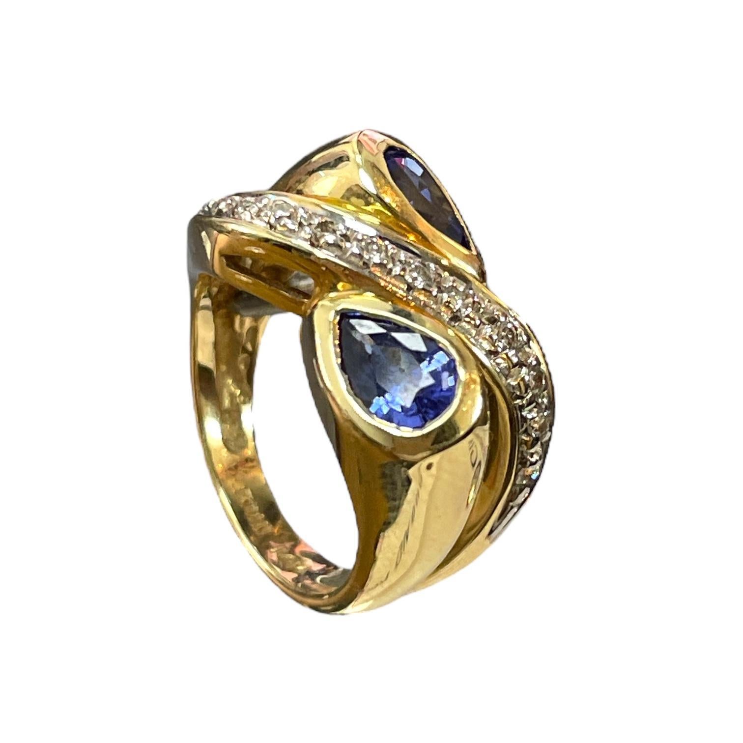 Embrace the swirling beauty of this 14K Yellow Gold ring, featuring a stunning pear-shaped tanzanite surrounded by sparkling diamonds. The elegant swirl design enhances the vibrant blue-violet hue of the tanzanite, creating a captivating piece that