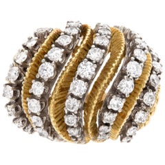 Swirls of diamonds in a cocktail ring in 18k. 1.50cts in round diamonds. Size 5.
