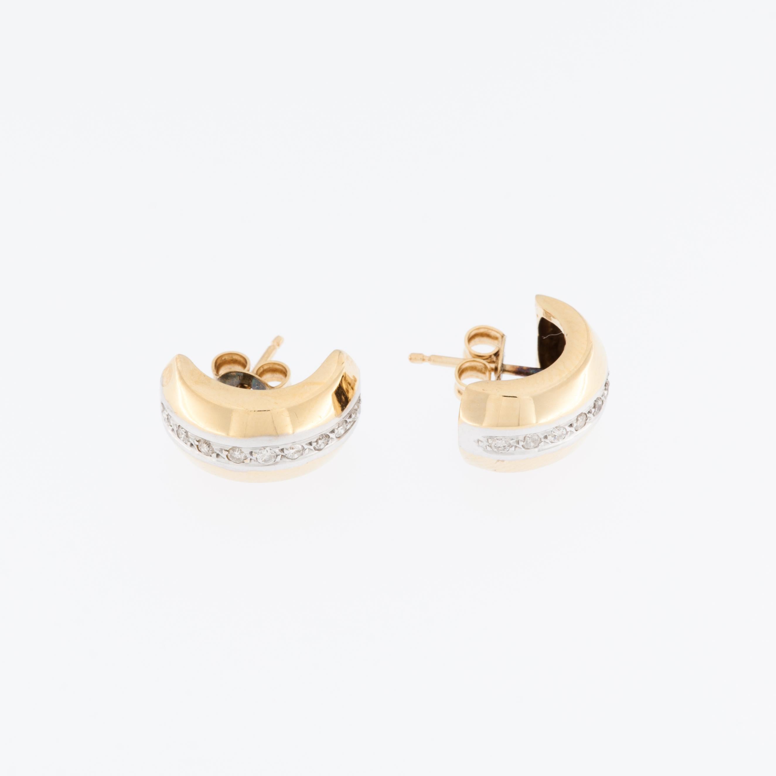 The Swiss 18kt Yellow and White Gold Earrings with Diamonds are a luxurious and exquisite jewelry item that combines the timeless beauty of gold with the dazzling sparkle of diamonds. 

These earrings are crafted from a high-quality blend of 18kt