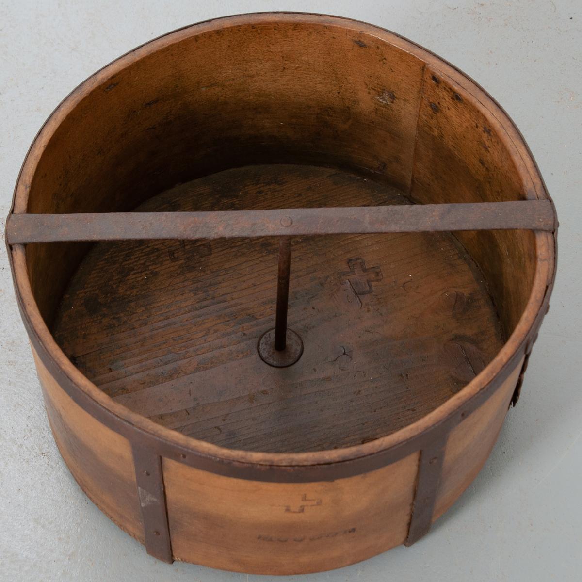 This dry grain measure is a handsome culinary antique. Beautifully aged wood with patinated hand-forged iron banding provides this piece with deep character. ‘Moudon’, a municipality in Switzerland, and the Swiss cross are branded into two sides of