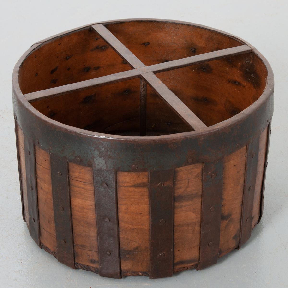 Questo misuratore di cereali secchi è un bell'oggetto d'antiquariato culinario. Il legno invecchiato e la fascia in ferro forgiato a mano patinato conferiscono a questo pezzo un carattere profondo. Ha un'abbondanza di lavori in ferro ed è davvero
