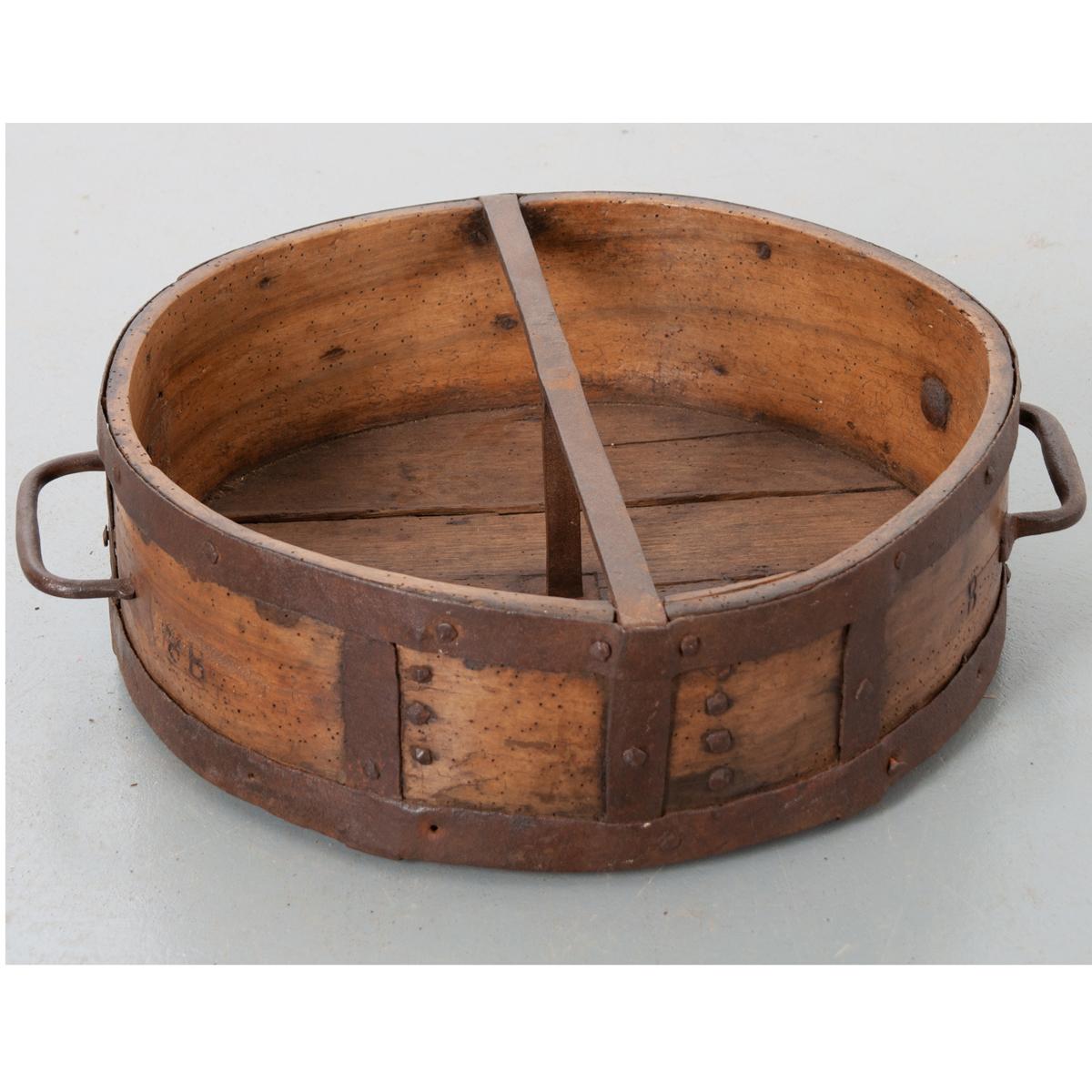 This dry grain measure is a handsome culinary antique. Beautifully aged wood with patinated hand forged iron banding provides this piece with deep character. It has the initials ‘B B’ on either side of the two iron handles.