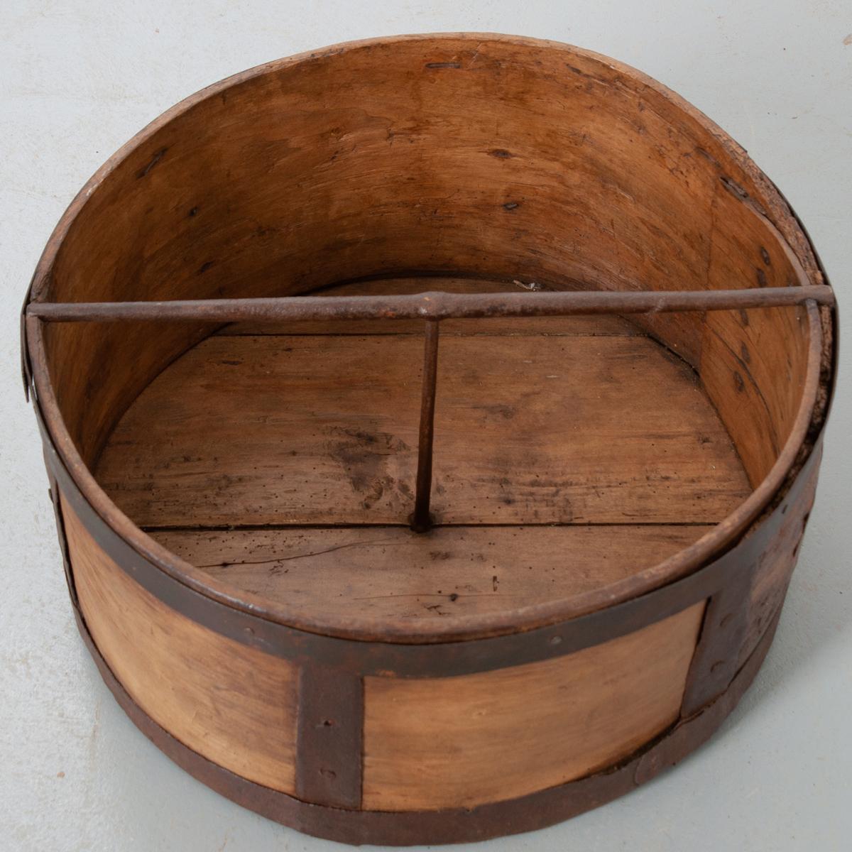 This dry grain measure is a large, handsome culinary antique. Beautifully aged wood with patinated hand forged iron banding provides this piece with deep character.
   