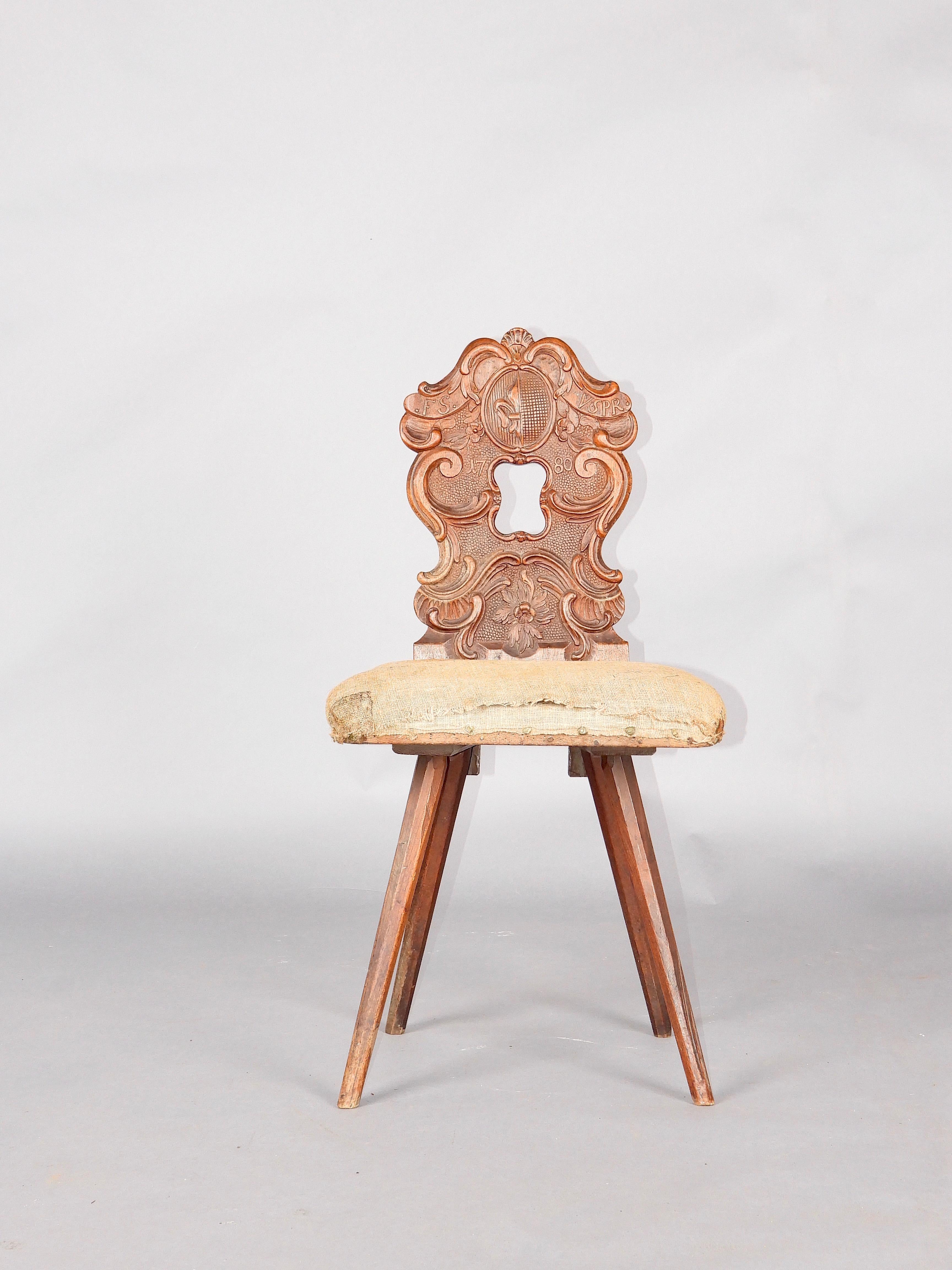 Swiss stool dated 1780 and richly sculpted, very rare model, the seat of which is in original fabric with its forged brass nails