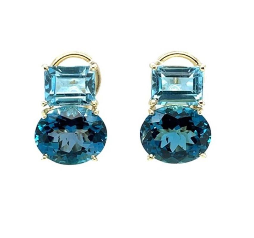 Two gorgeous shades of blue topaz are featured in these beautiful 18k yellow gold earrings with French clip backs. Bright emerald-cut sky blue topaz sit sideways at the top of the earring just above brilliant Swiss blue topaz ovals, also positioned