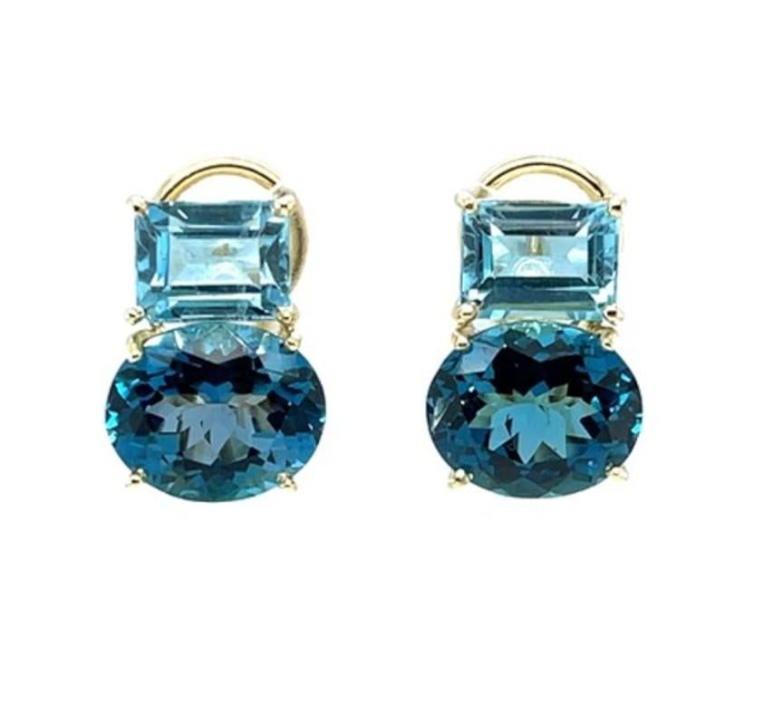 Diese wunderschönen Ohrringe aus 18 Karat Gelbgold mit französischer Klammer sind in zwei wunderschönen Blautopas-Schattierungen gehalten. Helle himmelblaue Topase im Smaragdschliff sitzen seitlich am oberen Ende des Ohrrings, direkt oberhalb von