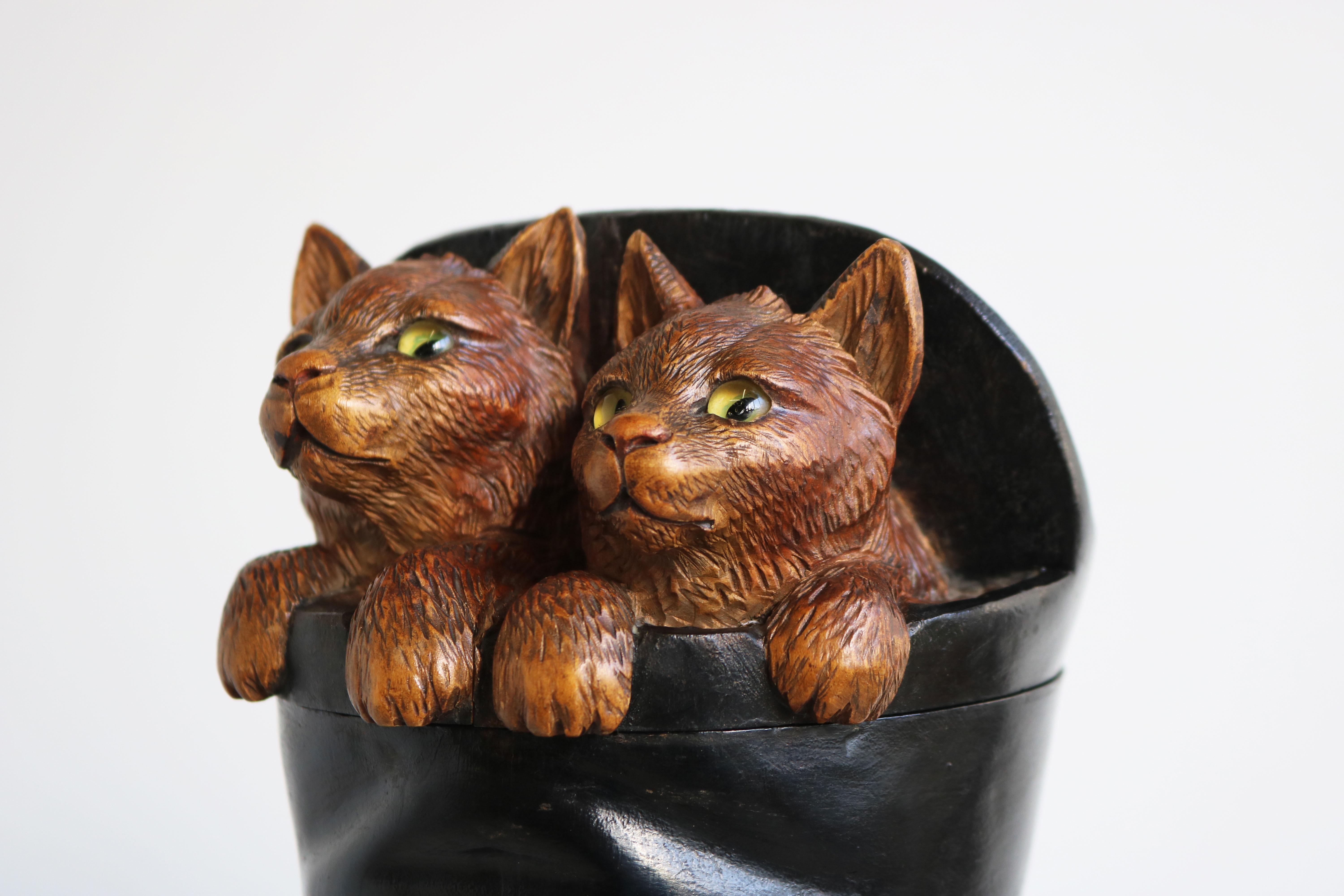 Exquisite 19th Century Swiss Black Forest cigar humidor / tobacco jar. Rare unusual model ''2 cats sitting in a top hat''.
Finely hand-carved cats with glass eyes, they have just the right feeling to them amazing craftsmanship. 
They peak out of