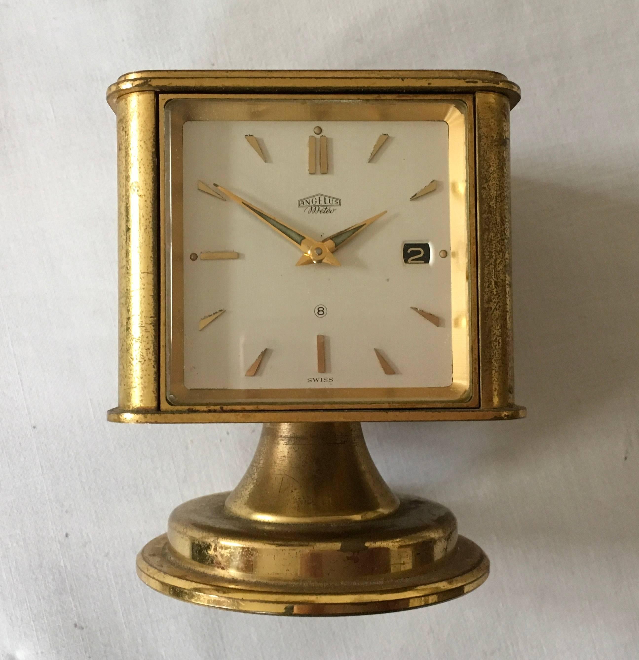 Brass construction with 8 days movement desk clock, Celsius or Fahrenheit thermometer, barometer, hygrometer, and compass.
Made in the 1930s in Switzerland by Angelus Meteo Watch Company.
Original working condition with some patina on the brass