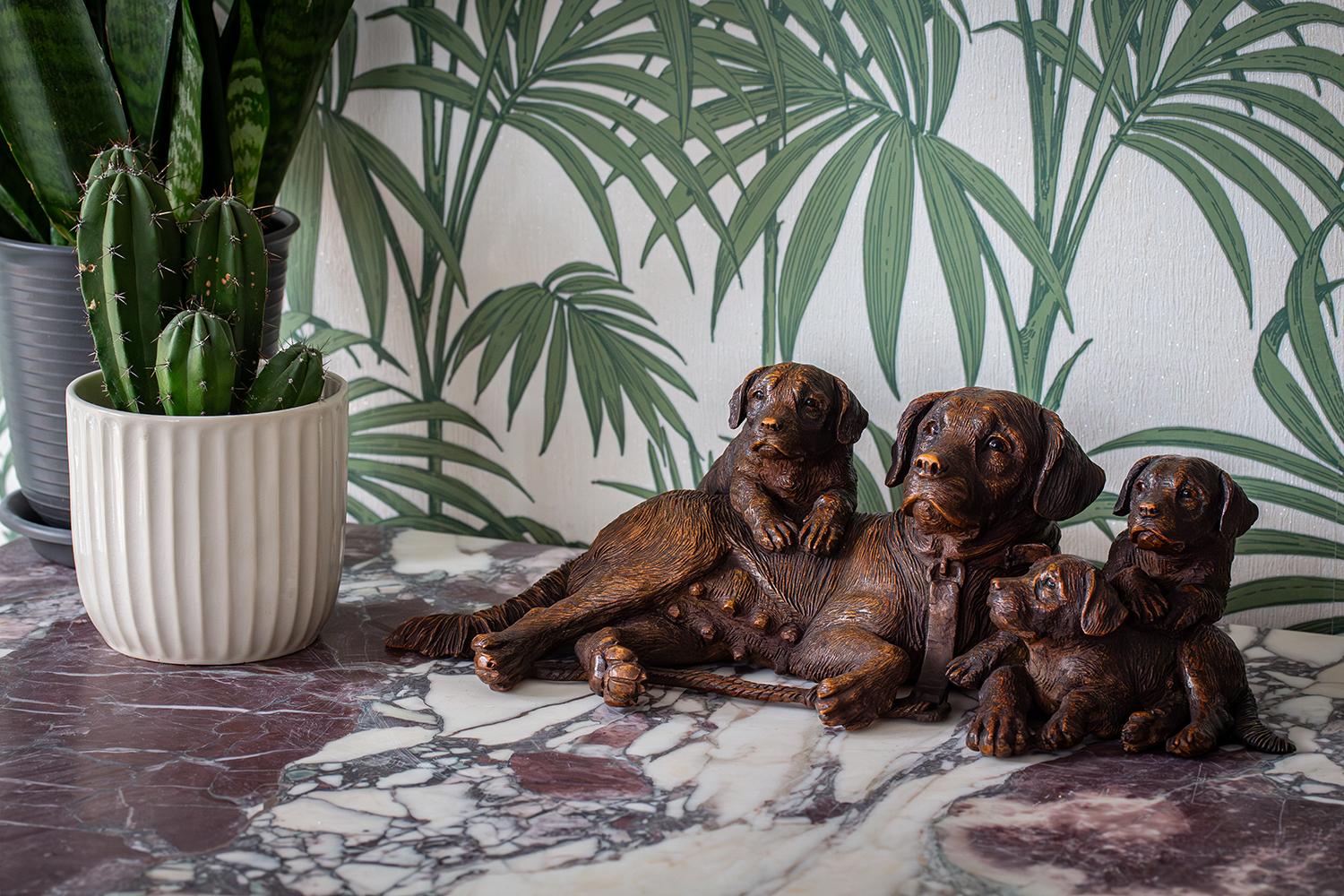 Featuring a Dog with Pups

Rare Swiss Black Forest Dog group. The group modelled as a smooth coat St. Bernard female with her three puppies. The group exceptionally carved with a fantastic patination featuring naturalistic details and each dog with