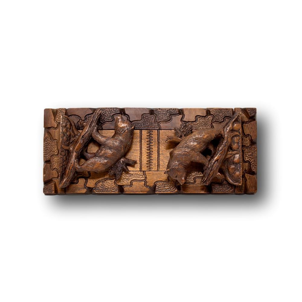 Swiss Black Forest extending book stand, book end. Carved in Black Forest linden wood with two end panels decorated with bears on all fours standing in front of a tree. Nicely carved in the typical Black Forest from the book end measures 56cm fully