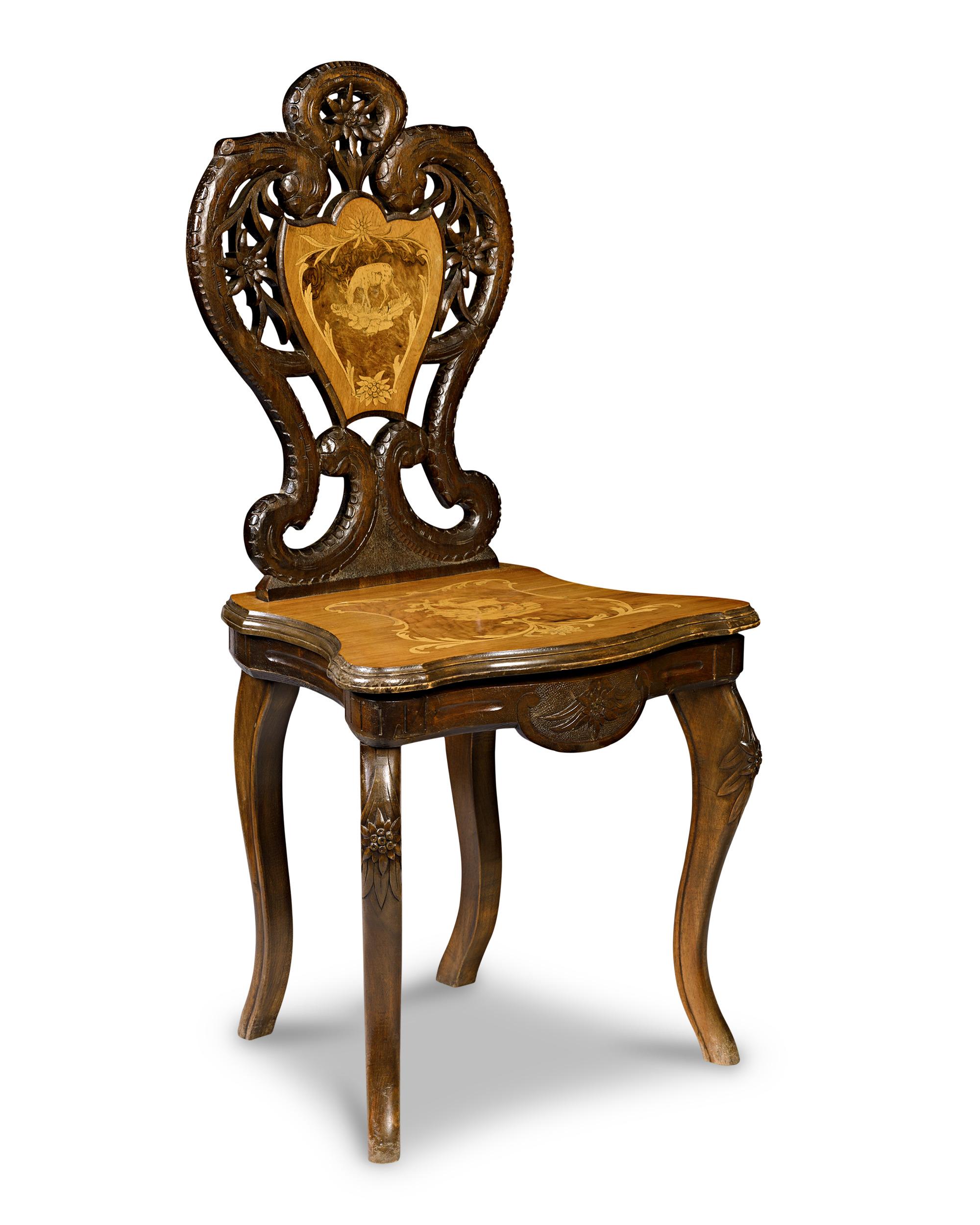 This exceptional Swiss Black Forest chair offers a delightful surprise—a music box hidden inside will activate when the chair is sat upon. A remarkable example of the intricate craftsmanship and artistic innovation characteristic of late