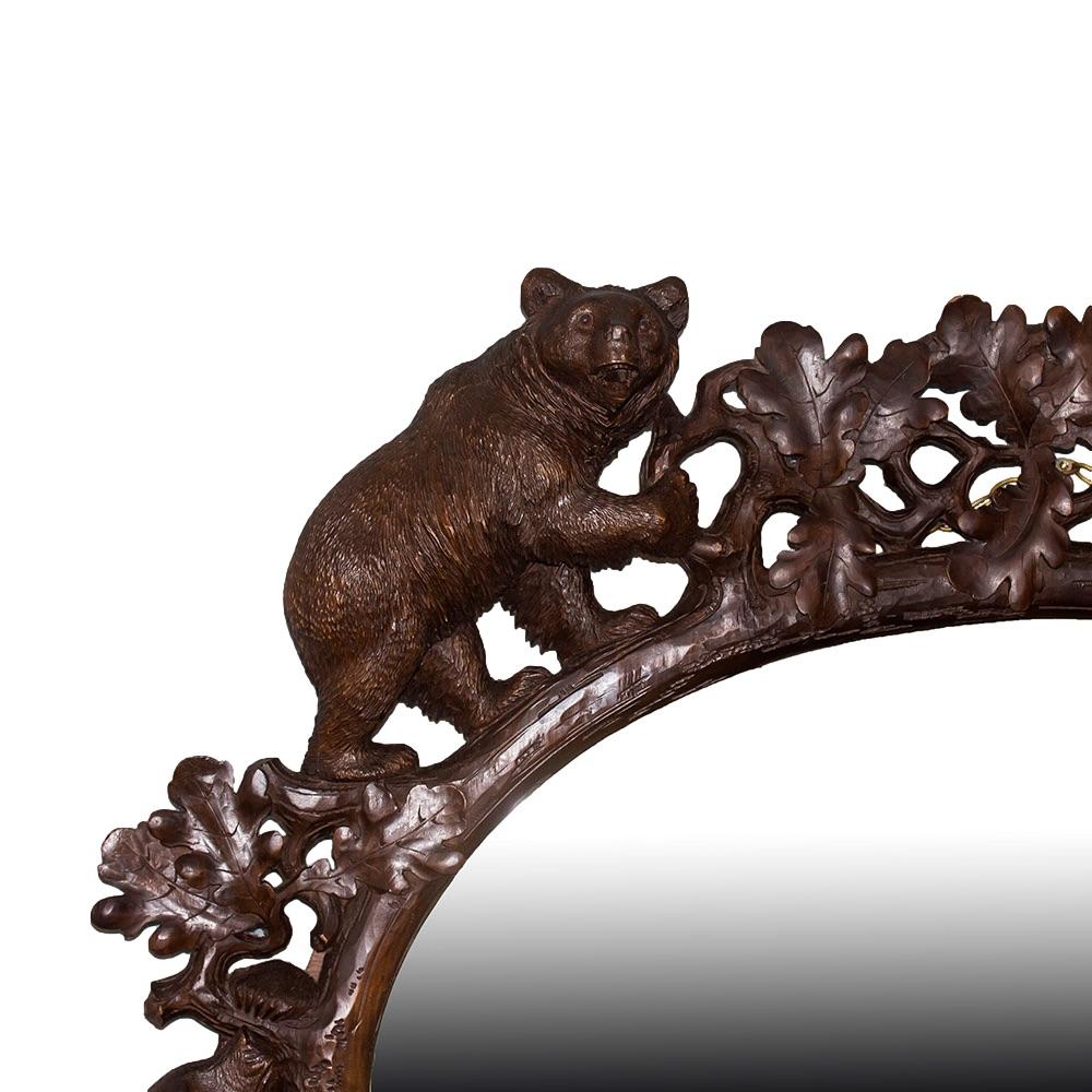 Fine and exceptionally rare Black Forest carved bear mirror. The mirror of exceptional size and detail with four large size bears climbing around the frame. Each bear with humorous expressions, two bears stand on all fours holding the top carved