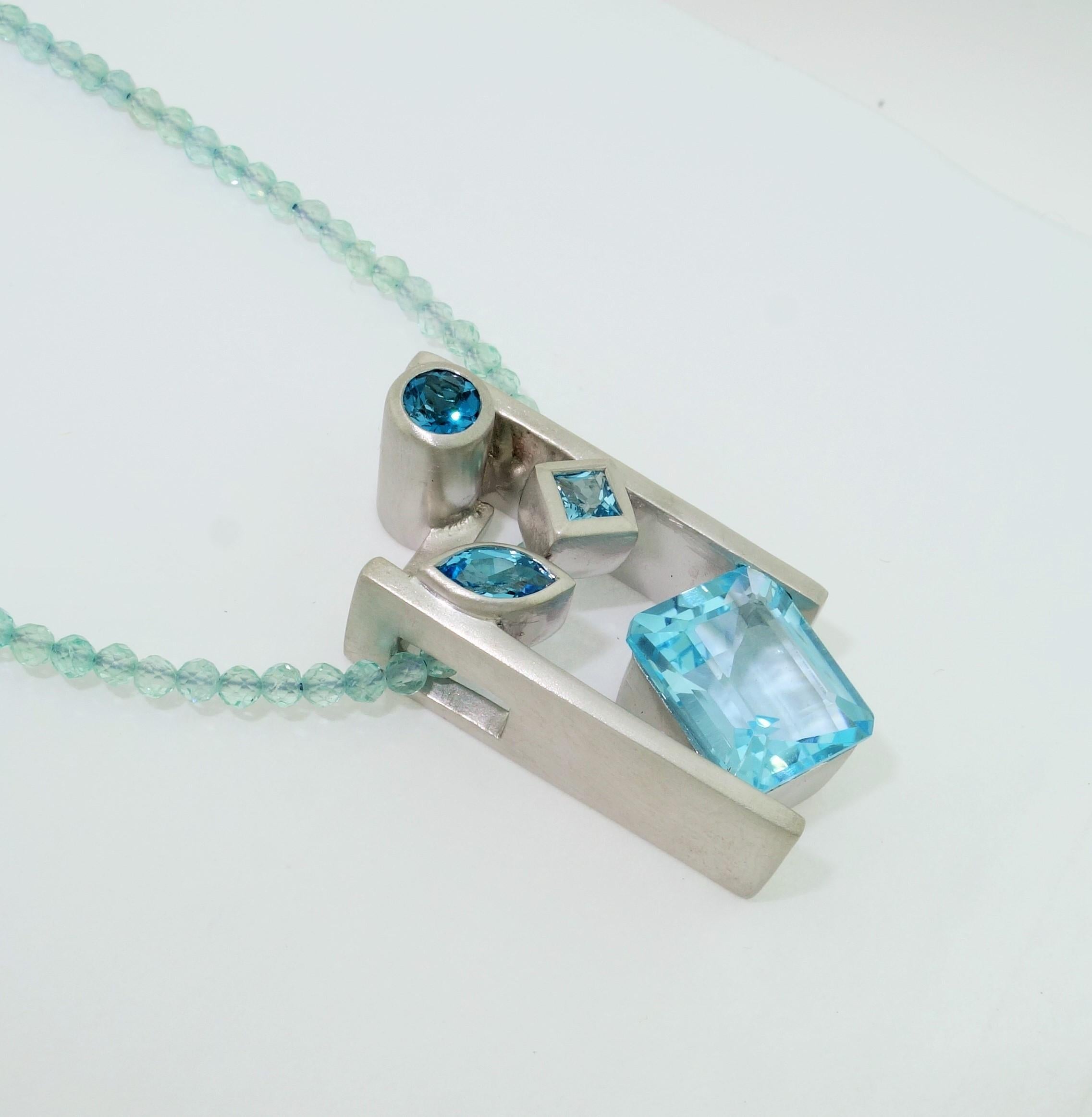 Beautiful and finely detailed Swiss Blue, London Blue and Sky Blue Topaz Pendant set in Sterling Silver and suspended from a Blue Apatite Necklace; approx. total weight of Topaz: 6.33 Carat; The pendant is Hand crafted in Rhodium Sterling Silver and