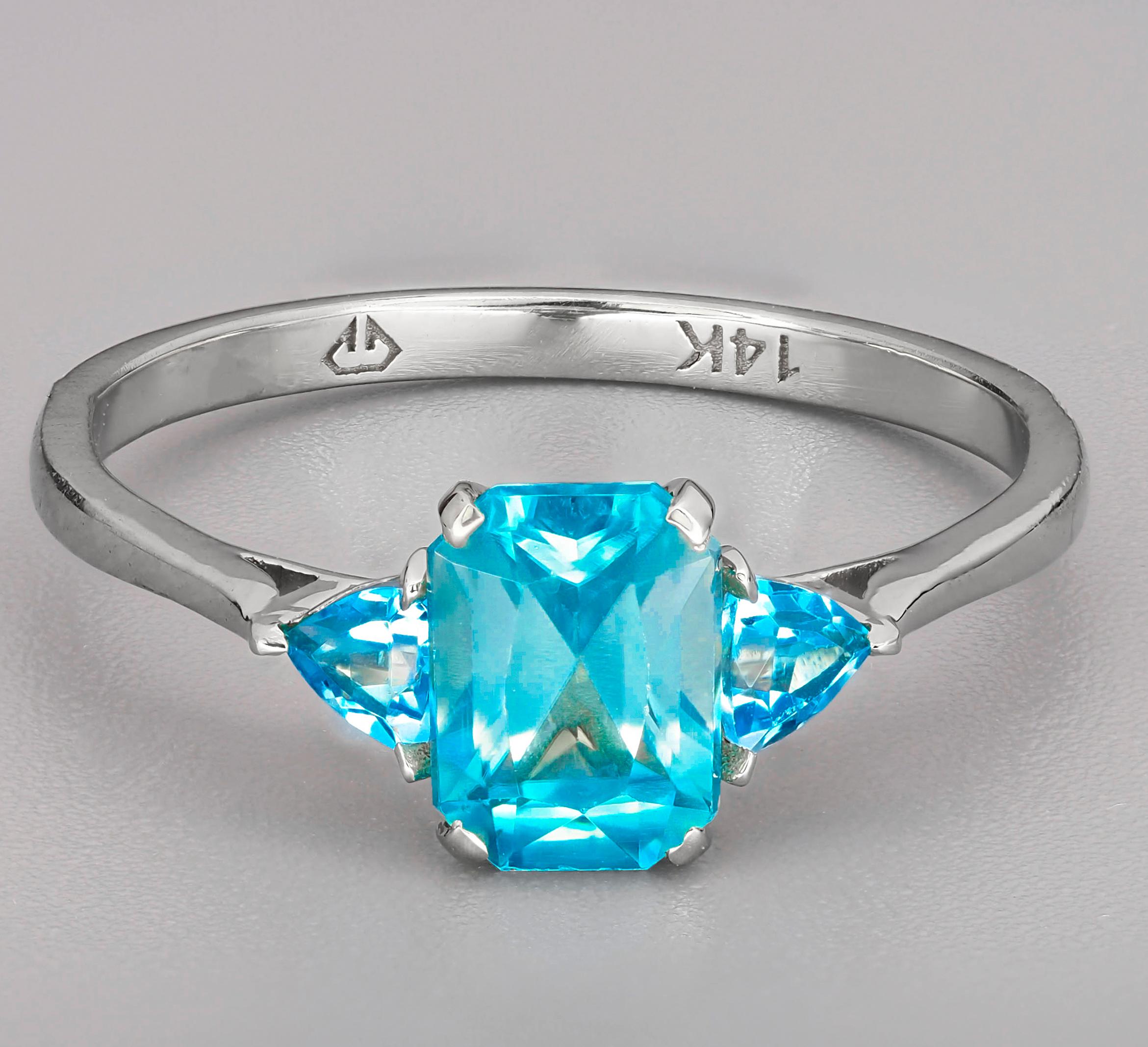 Swiss Blue Topaz 14k Gold Ring. 
November Birthstone Ring. Octagon topaz ring. 3 gemstone gold ring. Blue gemstone ring. Casual gold ring.

Metal: 14k gold
Weight: 1.8 g. depends from size.

Set with topaz, color - blue
emerald cut, aprx 0.80 ct. in
