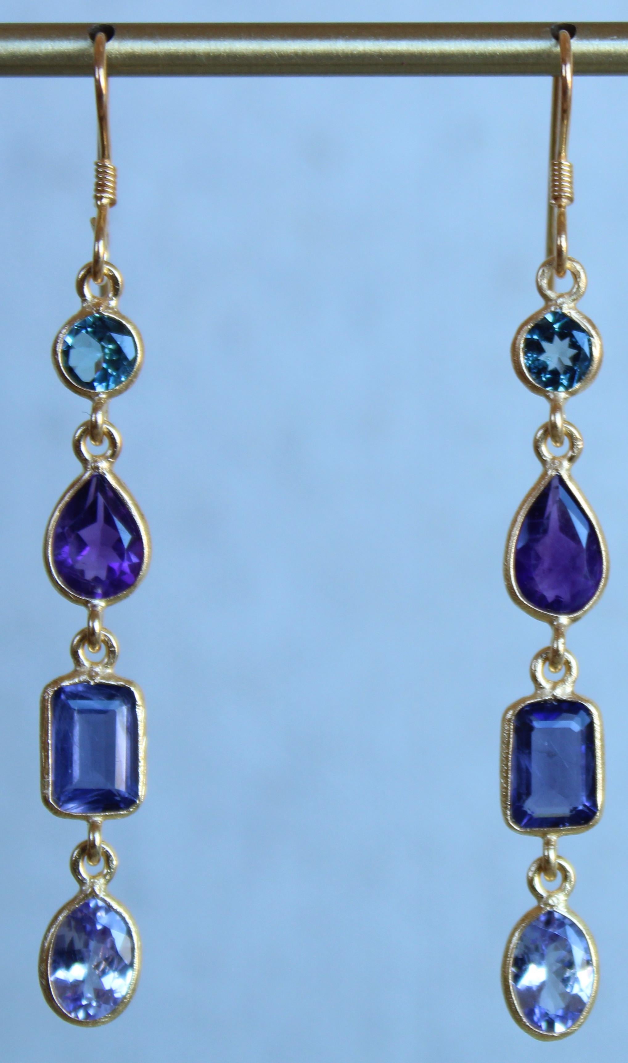 Shades of purple and blue, this stunning pear of earrings are exquisite. Comprised of Swiss Blue Topaz rounds, Amethyst pears, emerald cut Iolite and Tanzanite ovals, these earrings are such to receive compliments. The stones are set in a minimal