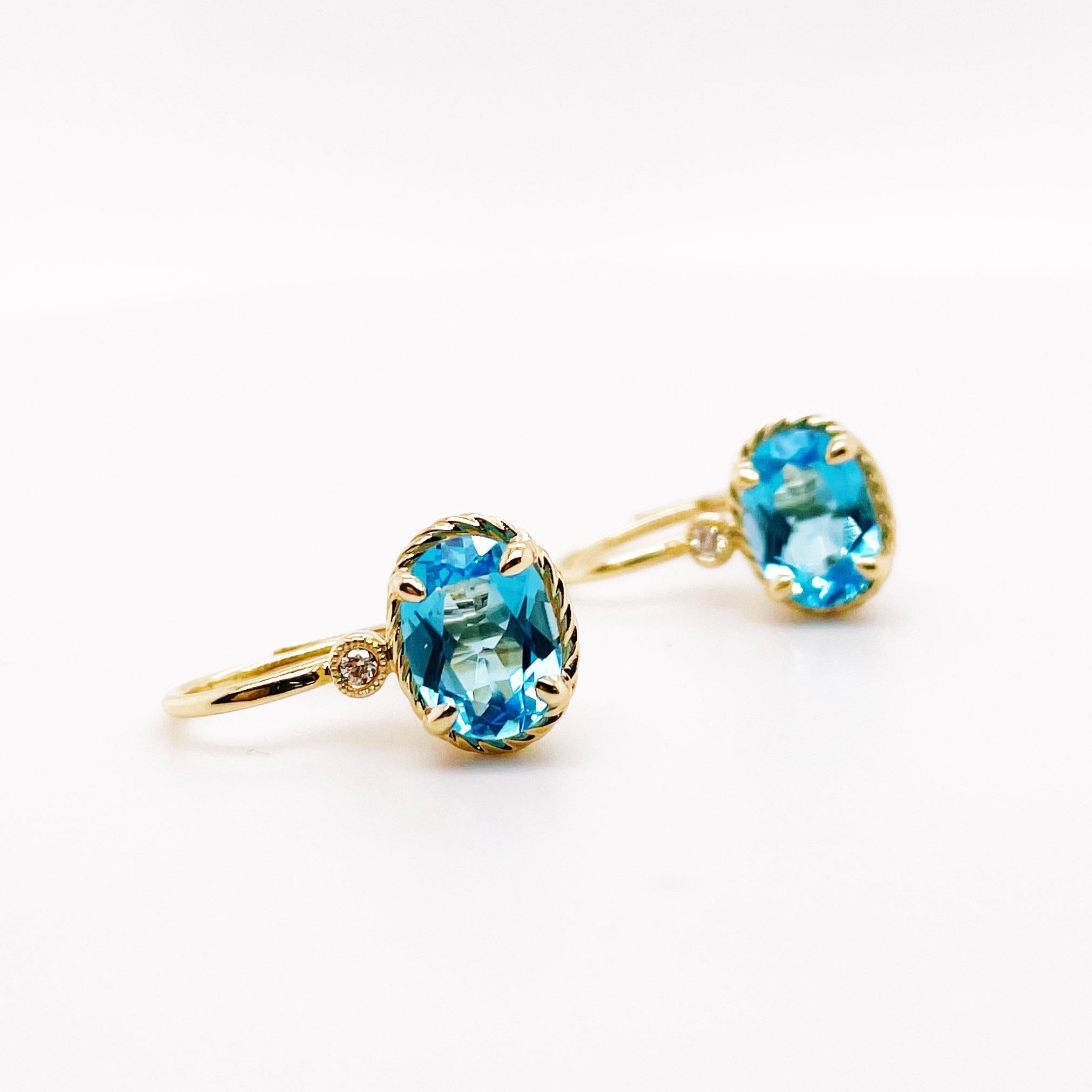 Do you want a touch of blue and diamonds in your earrings that can make your eyes pop without being too large? These earrings hang just right below your earlobe and really complete your accessories! The solid 14 karat yellow gold rope bezel and