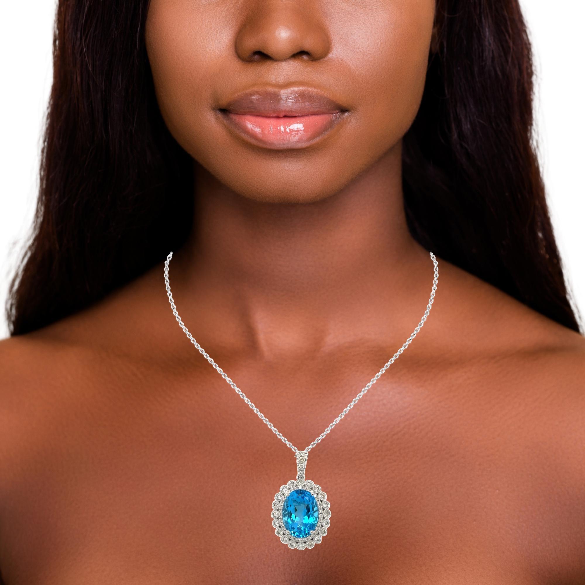 This stunning pendant has a 16x14 oval top quality Swiss Blue Topaz pendant surrounded by over 1 carat of 58 shimmery sparkling diamond. The Blue topaz is set in 14 karat white gold and comes with a white gold chain. It is brand new with detailed