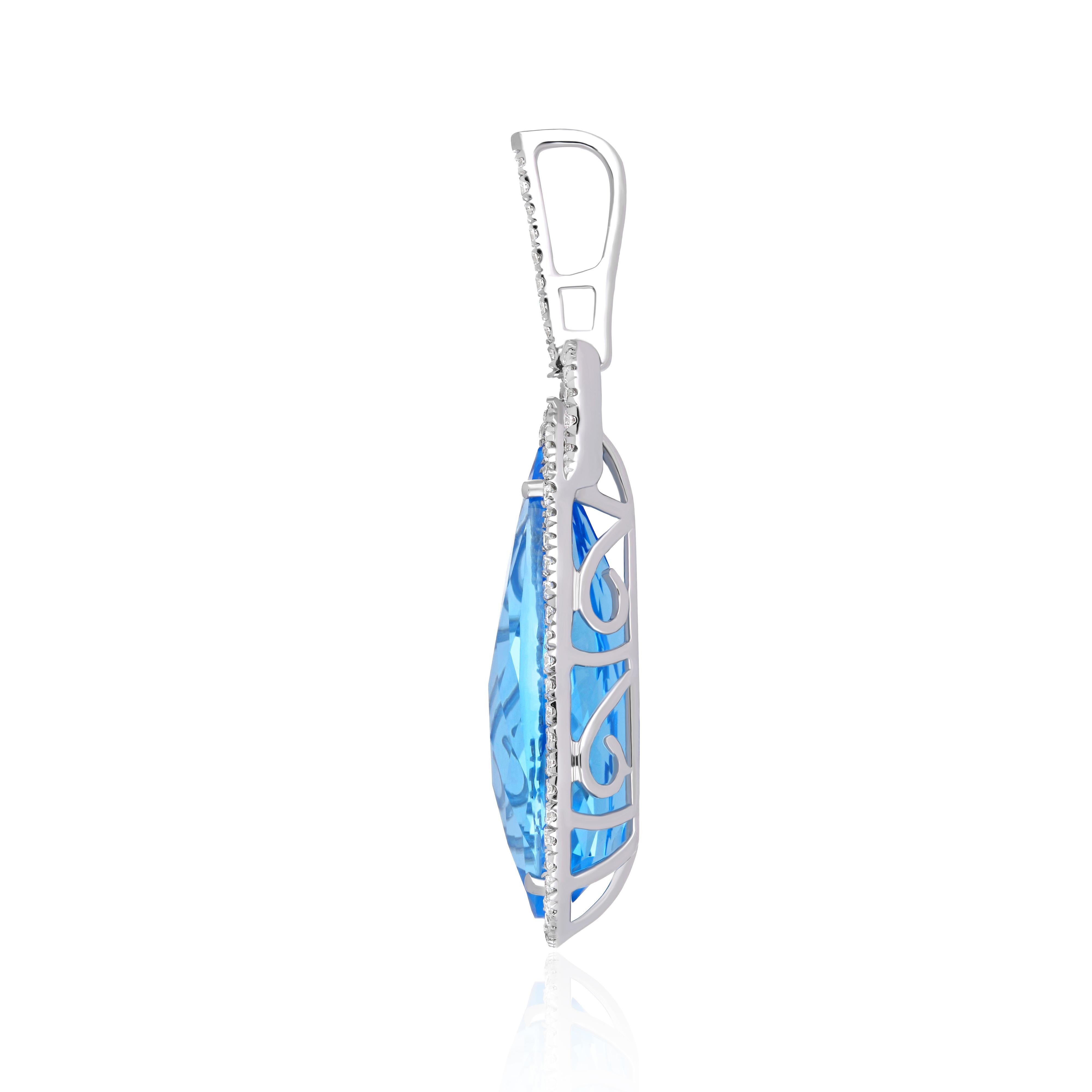 Elegant and exquisitely detailed Cocktail 14 Karat White Gold Pendant, center set with 10.18Cts. (approx.) Elongated Pear Cut Swiss Blue Topaz. Surrounded with micropave set Diamonds, weighing approx. 0.33 Cts. Beautifully Hand crafted in 14 Karat
