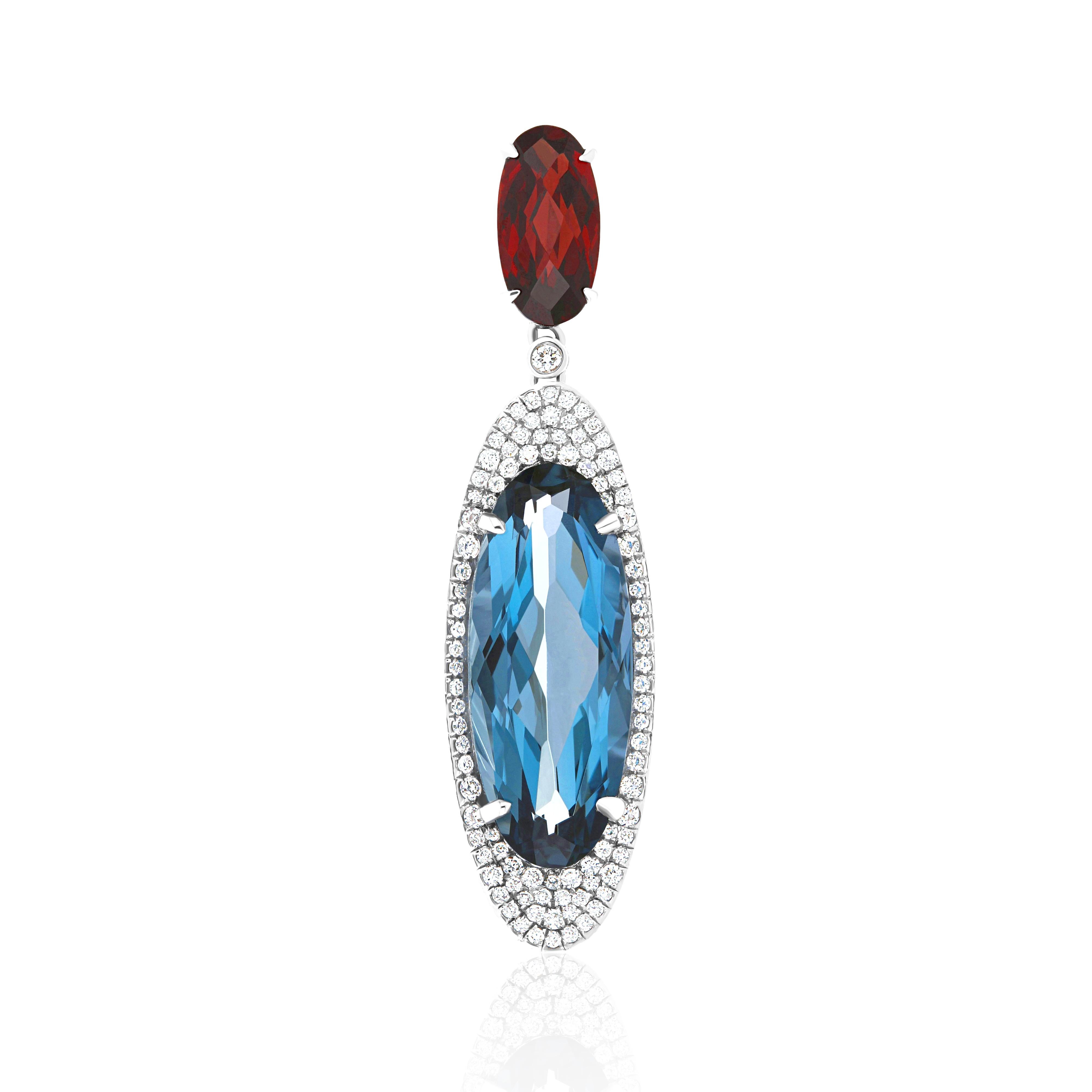 Elegant and exquisitely detailed Cocktail 14 Karat White Gold Pendant, center set with 7.78Cts. (approx.) Fancy Elongated Oval Shape London Blue Topaz,  accented with Fancy Elongated Oval Garnet weighing 1.66 Cts(approx.)  Surrounded with Diamonds,