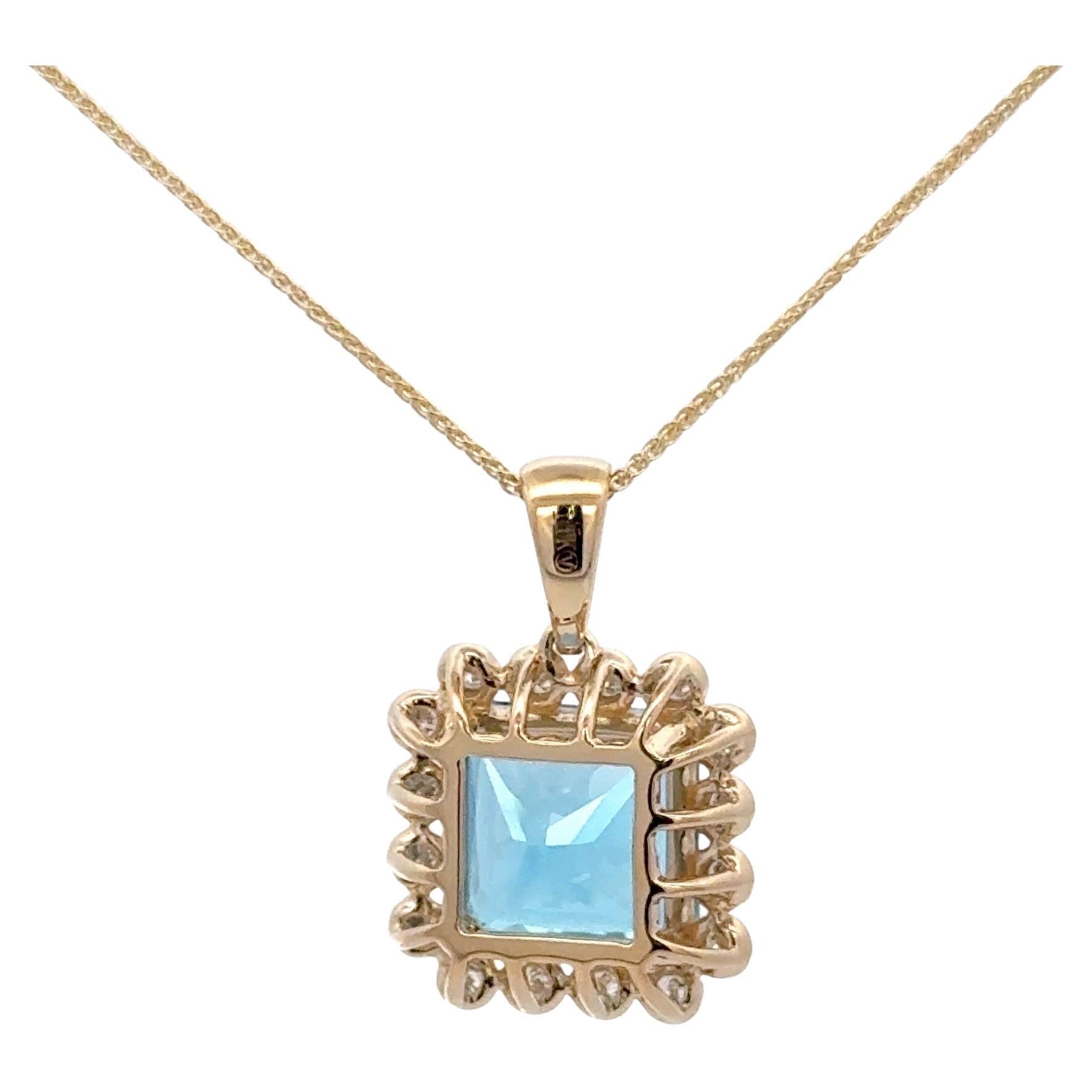 14 Karat yellow gold pendant featuring one radiant cut Swiss Blue Topaz weighing 5.70 carats flanked with 20 round brilliants, 0.40 carats. 
Measurement with Bale
7/8