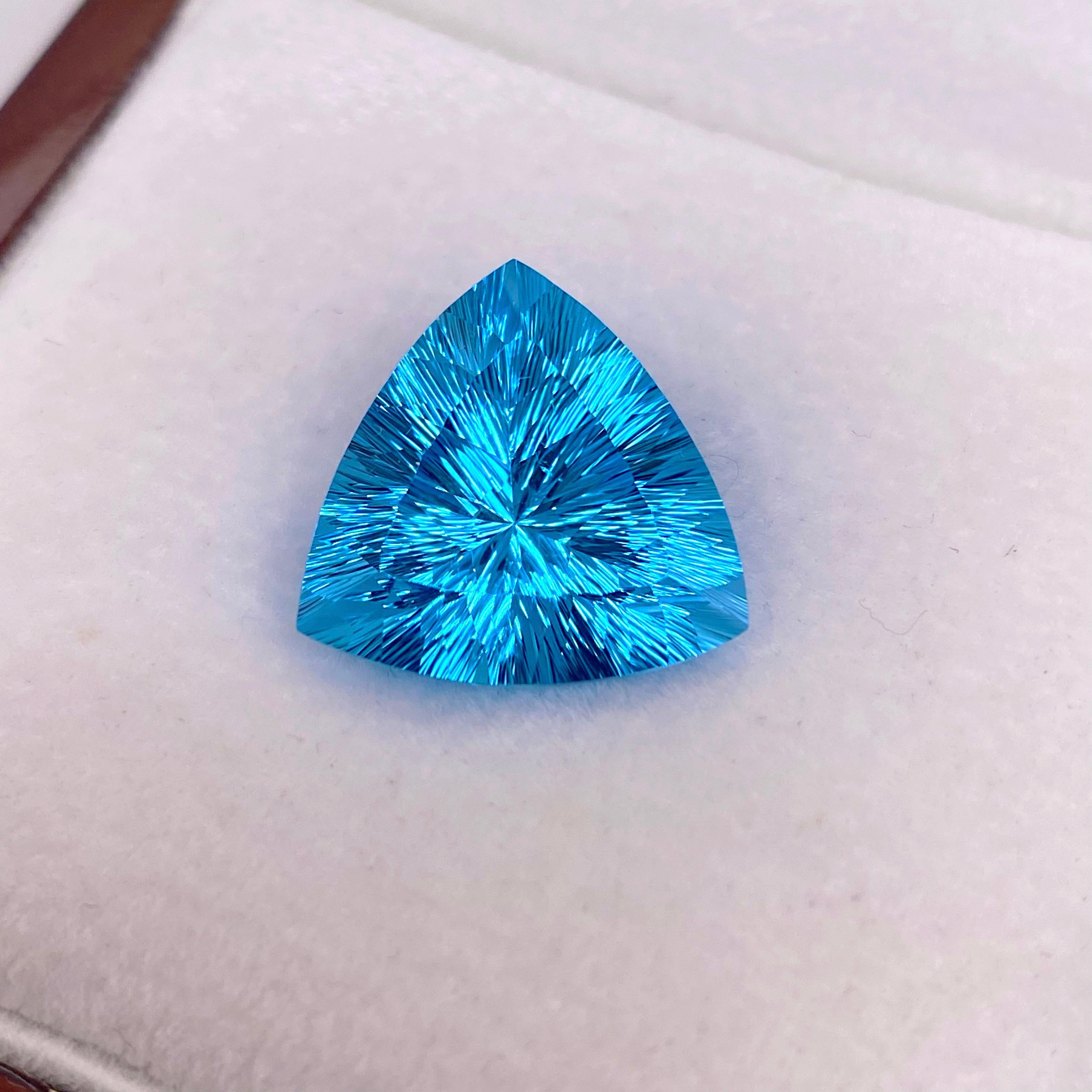This Brazilian Fantasy Gemstone weighs 18.13 carats and was very carefully cut by a well known cutter in Brazil. The London Blue Topaz is so sleek and has amazing reflections. The color of the topaz is a gorgeous bright, vibrant color and the sleek