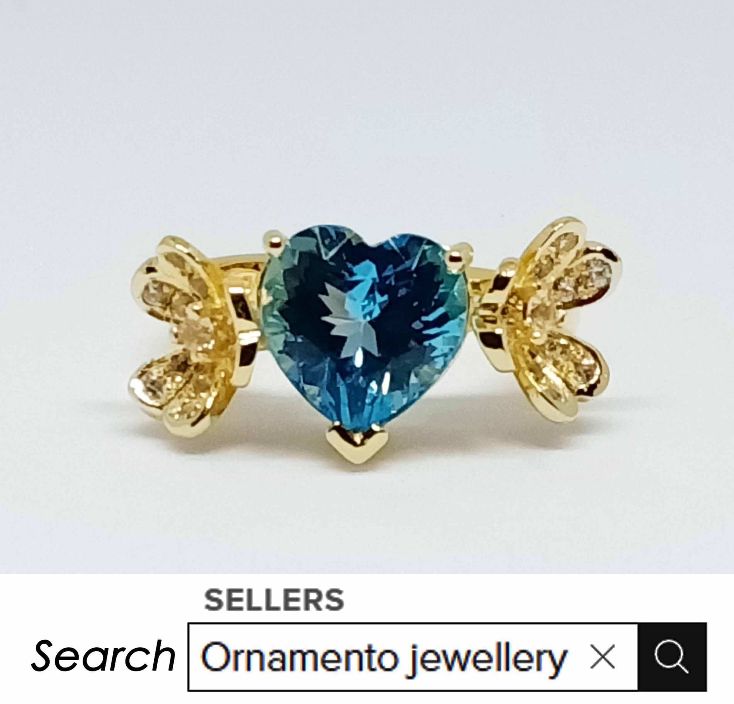 Swiss blue topaz. Heart shape 10x10mm. ( 4.06 cts )
White zircon 1.25 mm.
White zircon 2.0 mm.
Sterling Silver on 18K gold Plated.
Size 7 us.
(Can be resizable lower size not upper size )

Search (seller storefront) ornamento jewellery