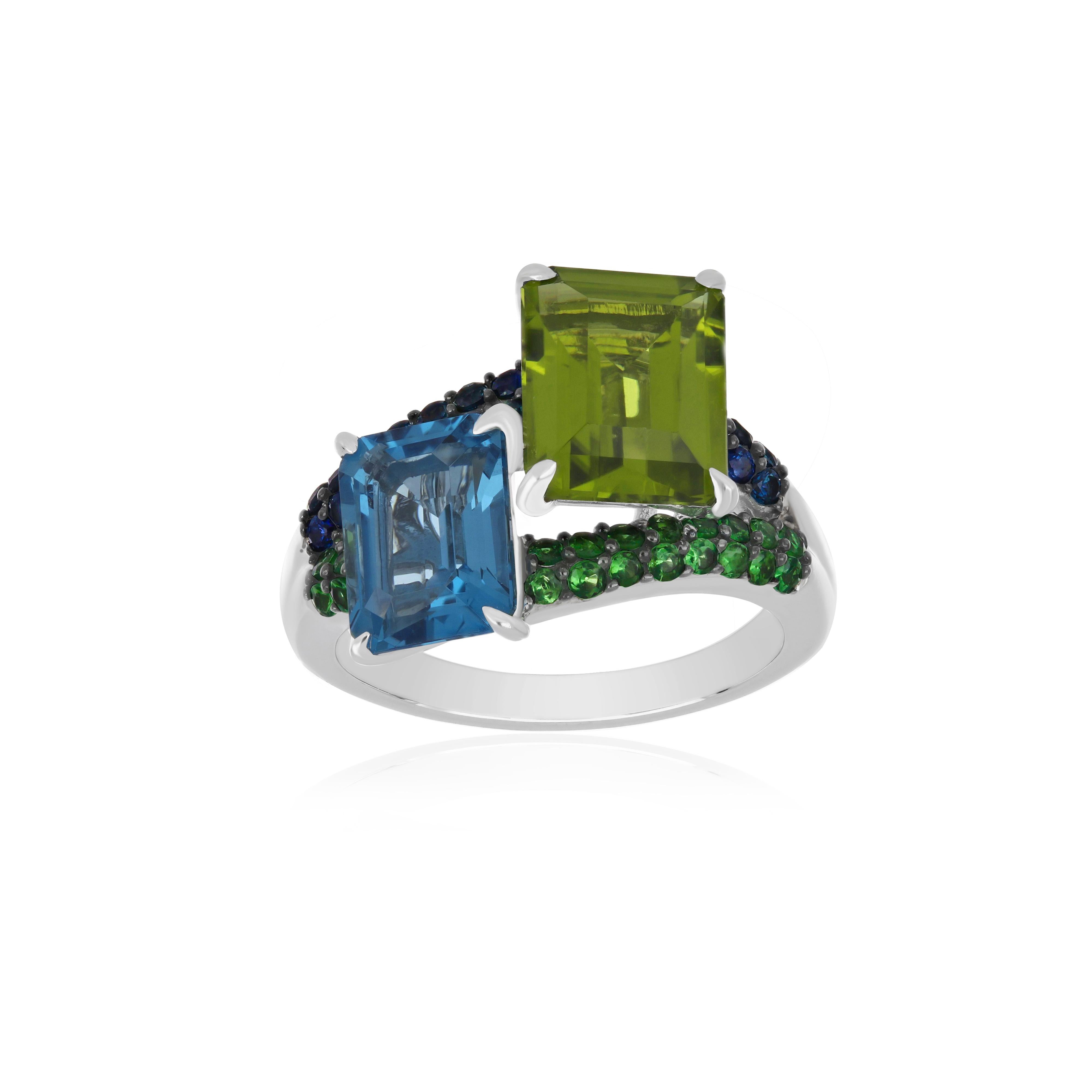 Elegant and exquisitely detailed 14 Karat White Gold Ring, studded with twin Octagon cut Swiss Blue Topaz weight 2.82Cts (approx.) & Peridot weight 3.30Cts (approx.) accented with 1.50 mm Blue Sapphire Weight 0.40Cts (approx.) & Tsavorite Weight
