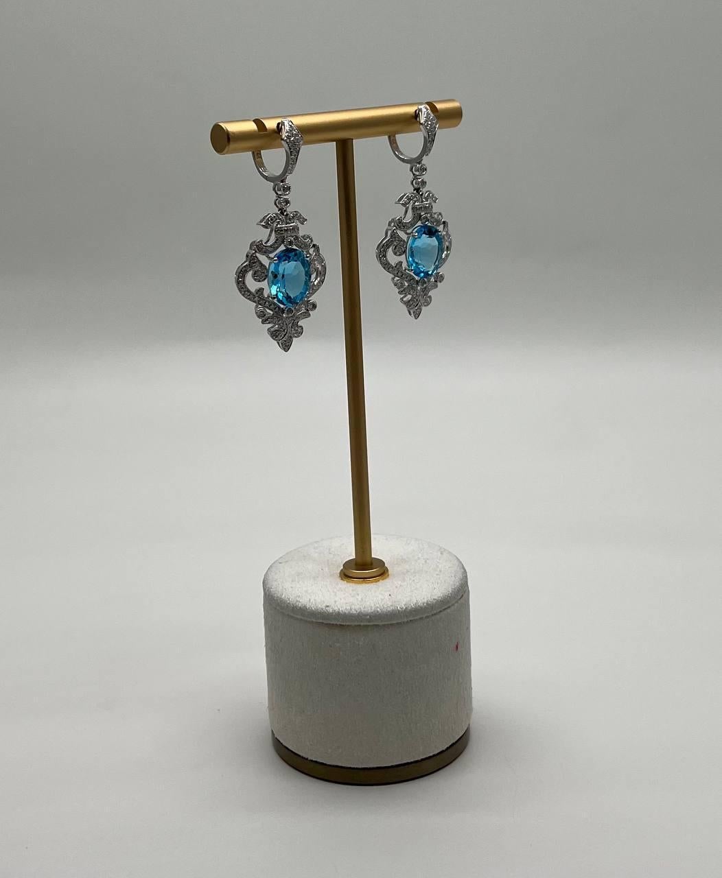 A stunning pair of earrings featuring intricate 14K White Gold detailing. Each earring showcases a vibrant blue Swiss Blue Topaz, elegantly framed by ornate 14K White Gold. These earrings embody modern elegance with a touch of sophistication.
14K