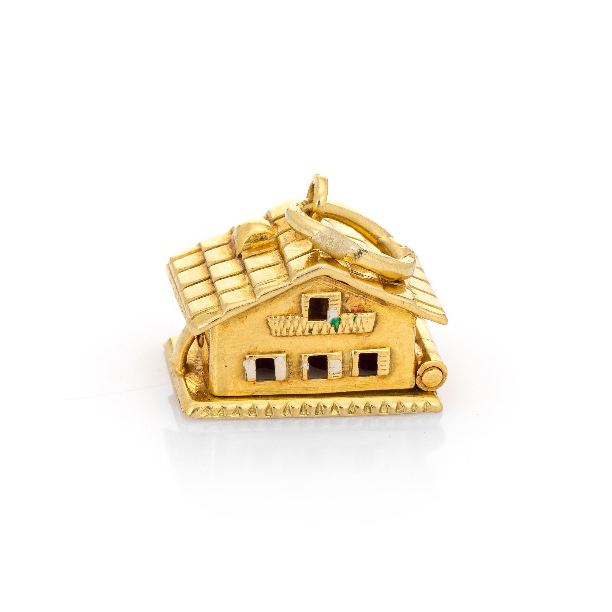 Finely detailed vintage Swiss Chalet charm crafted in 18k yellow gold.  

The unique charm is beautifully detailed with a tiled roof and windows, and opens to reveal two enameled hearts. How sweet! The bale measures 3mm and can accommodate a thin to