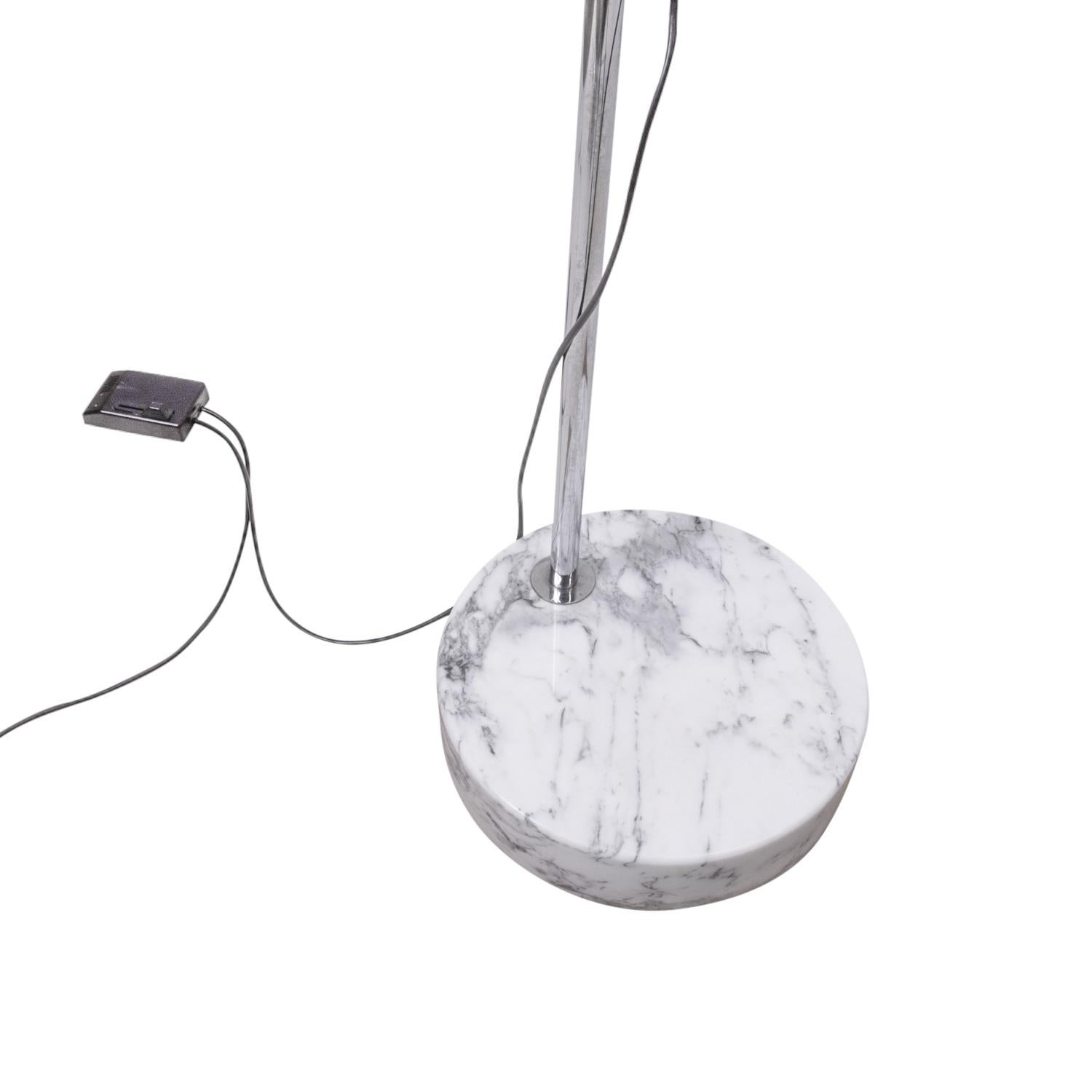 The Halo-Mobil floor lamp by Rico and Rosemarie Baltensweiler was designed in the 1970s. Our version comes with a marble base.

This arched floor lamp (adjustable in height) is an impressive appearance due to this size and futuristic appearance of