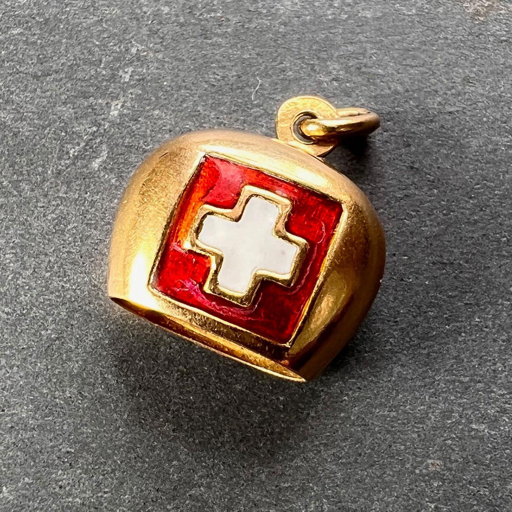An 18 karat (18K) yellow gold charm pendant designed as a bell with enamel Swiss flag. Clapper missing. Stamped with the Swiss mark for 18 karat gold. Some chips to the enamel.

Dimensions: 1.4 x 1.4 x 0.75 cm (not including jump ring)
Weight: 1.86