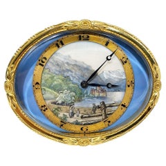 Reloj de sobremesa ovalado de latón dorado suizo con paisaje suizo pintado