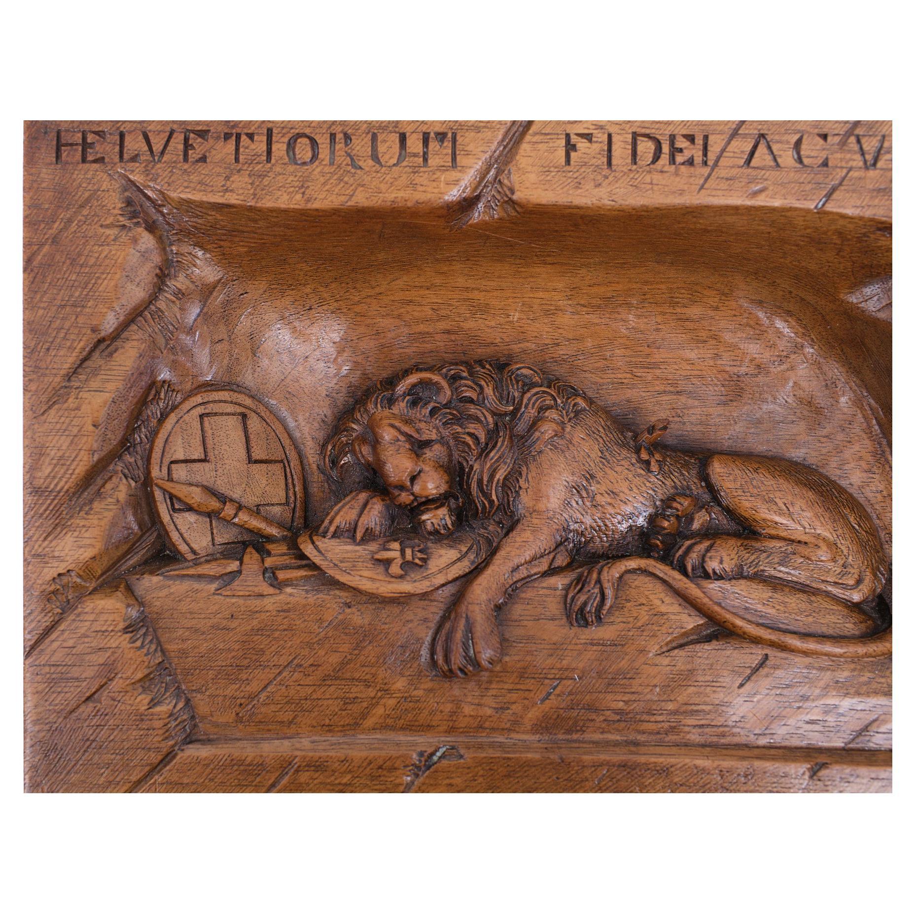 Fine lion wood carving relief depicting the Swiss deadly wounded lion of Luzerne. The original statue reminds of the deadly wounded Swiss guardsmen of 1792. Brienz, circa 1900.
