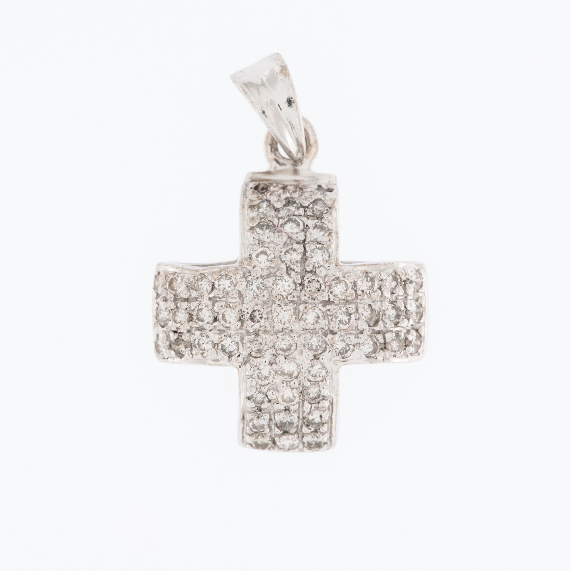 The Swiss Modern 18kt White Gold Cross with Diamonds is a marvelous piece of jewelry that exudes elegance and timeless charm. 

This cross pendant is crafted from 18-karat white gold, which is known for its brightness. The use of high-quality gold