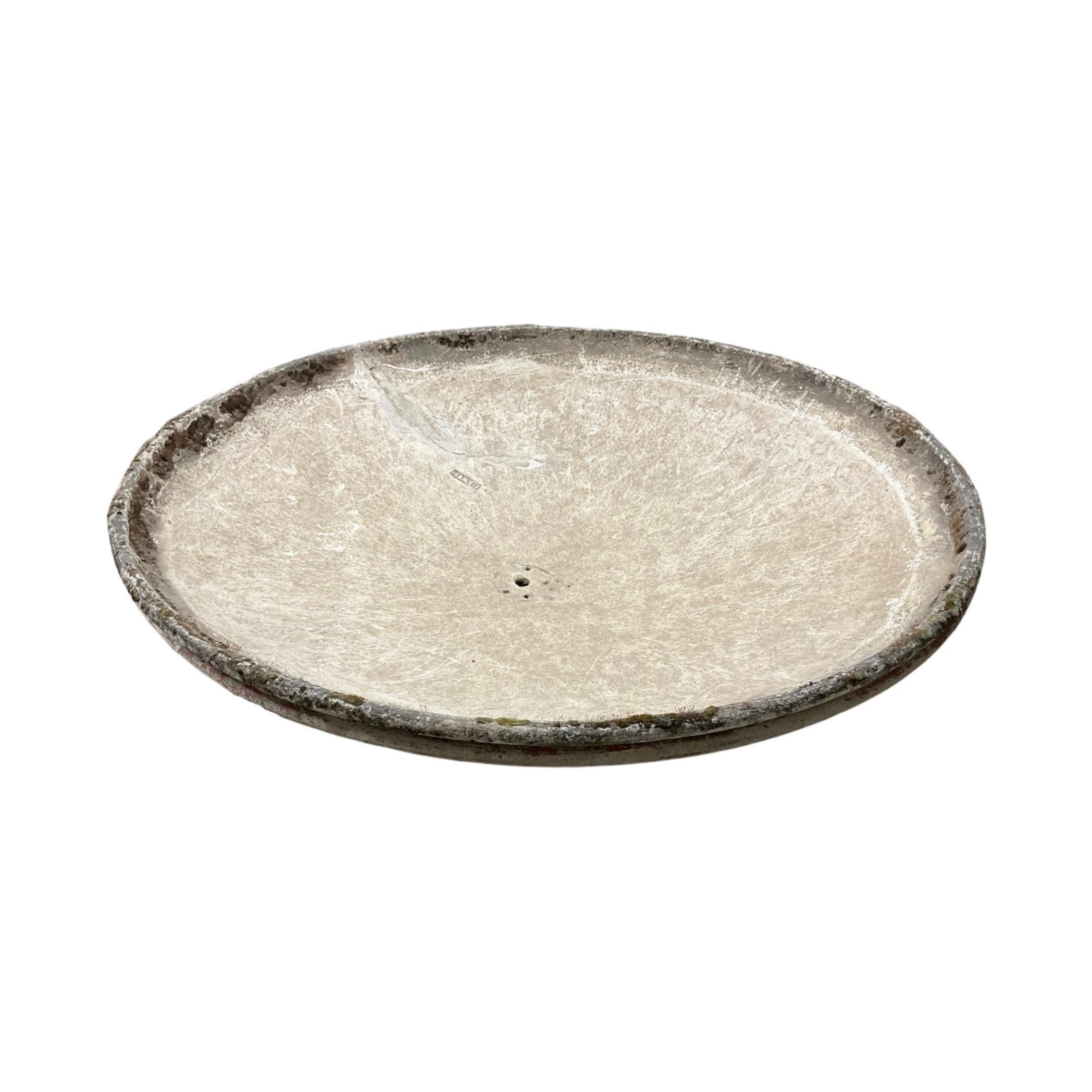 This Swiss saucer planter by Willy Guhl is a 19th century design made from a durable limestone composite. The planter includes a custom tri stand, offering an elegant display for flowers or plants. Bring Swiss design history to your outdoor space