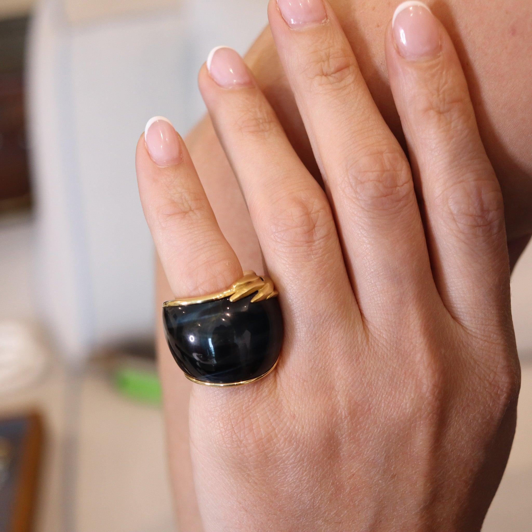 Sculptural Hawk Eye Gemstone Ring Band.

Fabulous contemporary ring band with gorgeous design, created in Switzerland back in the 2000. The main focus is the carved piece of Hawk's Eye gemstone which mounted in a customized setting made up in solid