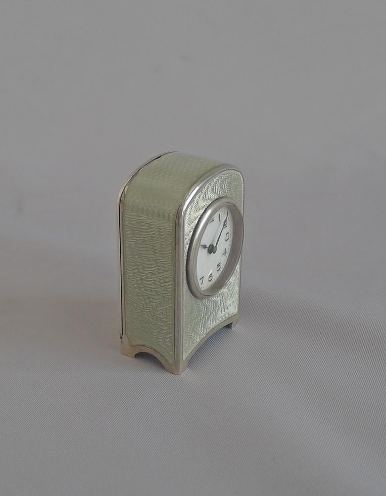 Antique Swiss sub miniature silver and guilloche enamel carriage clock. In superb condition, the heavily patterned engine turned silver overlaid with fine grey guilloche enamel giving a stunning effect. Fine dial with Arabic numerals and blued steel
