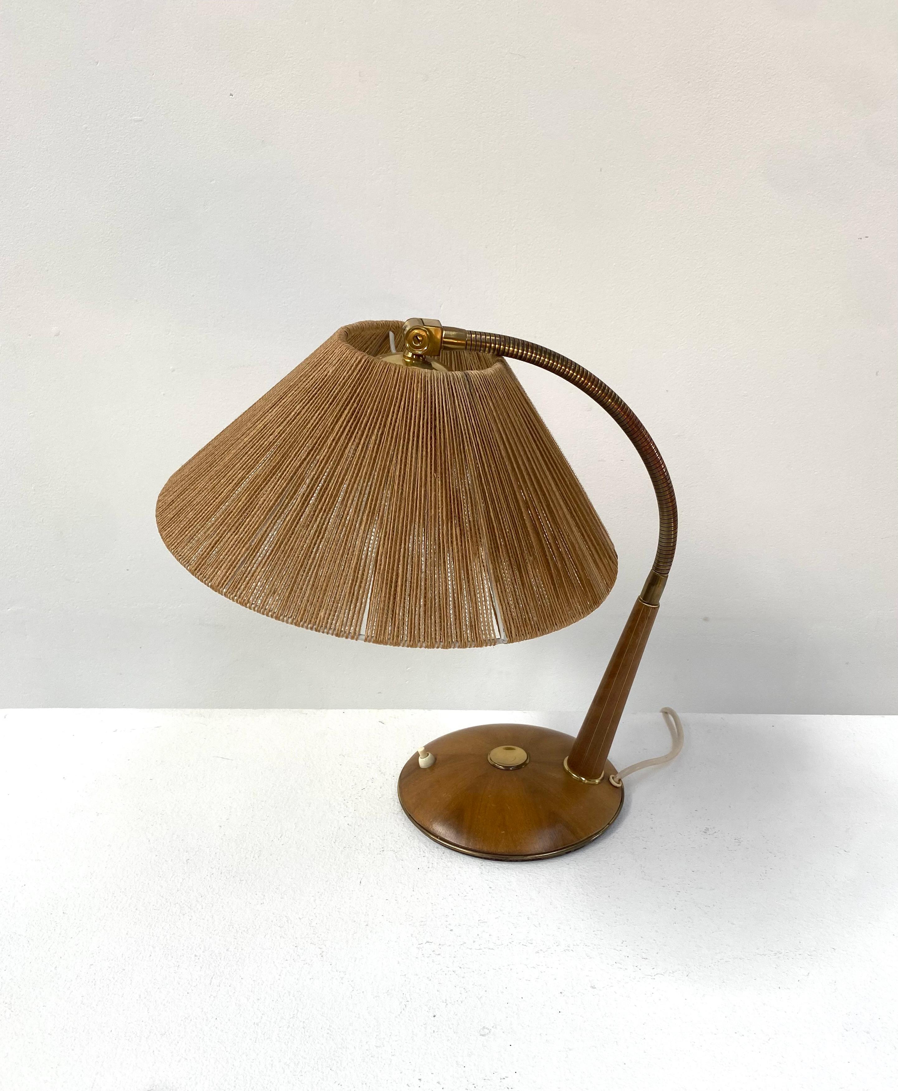 A great Danish table lamp made of teak, brass and sisal. Model 2655. Designed and manufactured in Switzerland by Temde Leuchten in the sixties by Temde in Switzerland. The sisal lampshade in combination with a E27 (US E26) light bulb creates a
