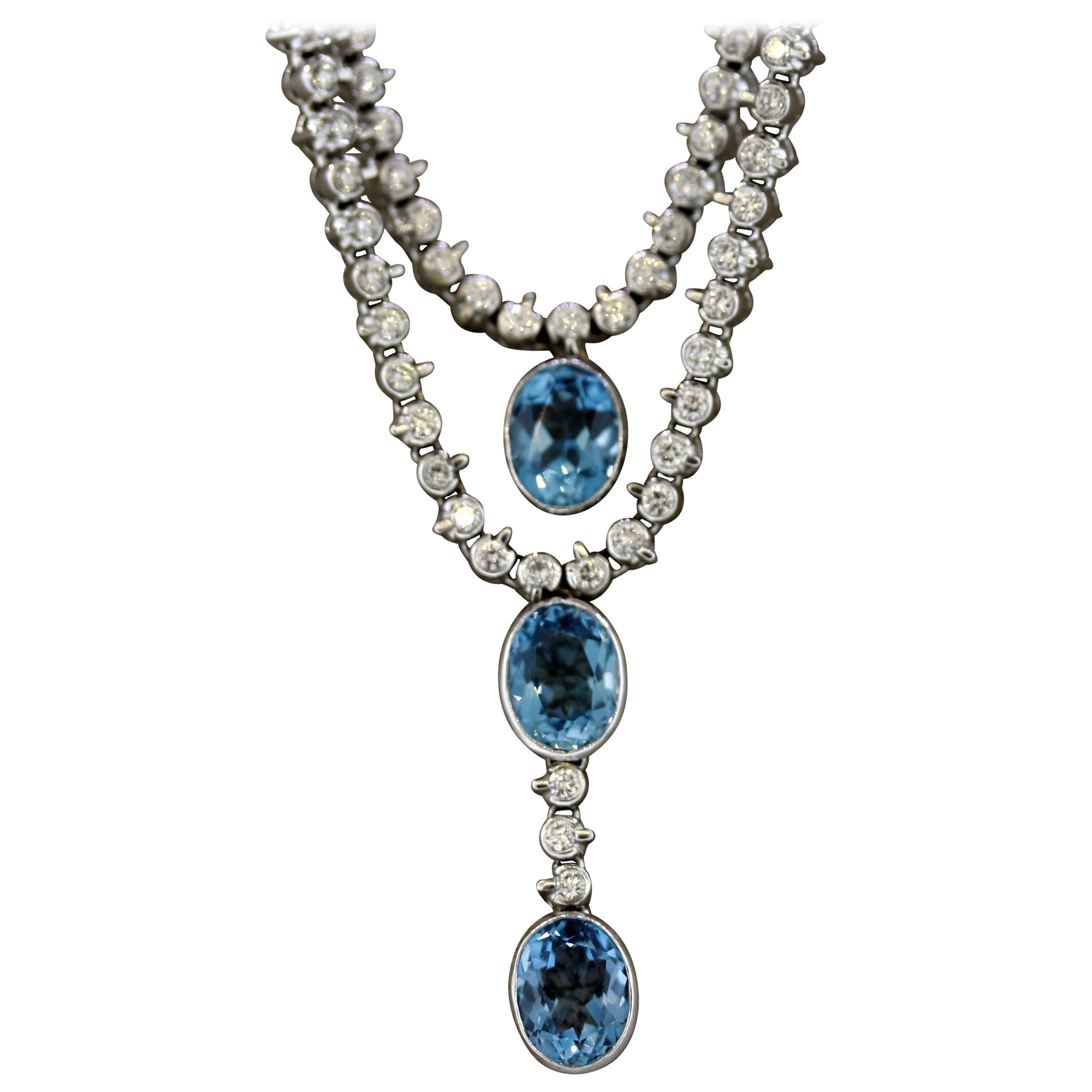 A sweet and elegant necklace featuring 3 large swiss blue topaz. They are cut in matching oval shapes and have a bright rich sky-blue color giving them the trade name “swiss” topaz. They are accented by 5.90 carats of round brilliant cut diamonds