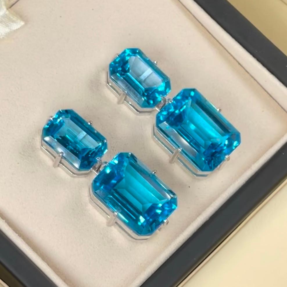 18k Solid White Gold 
Genuine Swiss Topaz, Emerald Cut, Size 10x13 and 12.5x17.5mm/each side, Rectangle Shape.
Total Weight: 20.8g

Swiss Topaz Pendant Earrings – 18K Solid White Gold
Sculpted in luminous 18K solid white gold, these pendant earrings