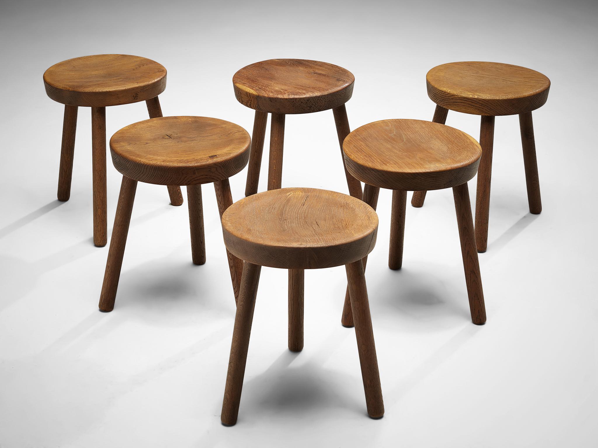 Tripod stools or side tables, solid oak, Switzerland, 1960s-1970s.

Beautiful crafted oak stools originating from the exhibition center in St. Gallen, Switzerland. The seat is handcrafted to have a small dip for better comfort. With their simple